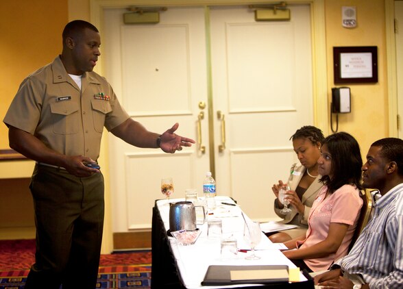 Capt. LaBarron McBride, an instructor with Officer Candidates School, Marine Corps Base, Quantico, Va., discusses a leadership case study with Atlanta-area college students during Marine Corps Leadership Seminar - Atlanta April 29.  The inaugural event brought together senior Marine leaders and administrators, professors, and students from Atlanta-area colleges and universities for a two-day, hands-on seminar focused on Marine Corps leadership development.