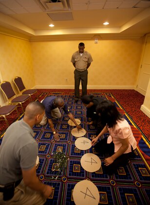 Capt. LaBarron McBride, an instructor with Officer Candidates School, Marine Corps Base, Quantico, Va., guides Atlanta-area college students through a leadership problem solving exercise during Marine Corps Leadership Seminar - Atlanta April 29.  The inaugural event brought together senior Marine leaders and administrators, professors, and students from Atlanta-area colleges and universities for a two-day, hands-on seminar focused on Marine Corps leadership development.