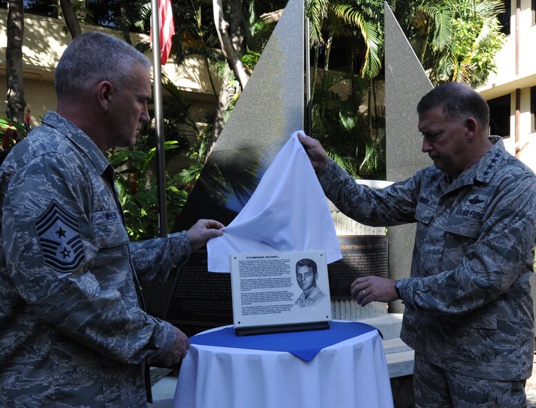 Chief Master Sgt Brooke McLean, PACAF command chief, (left) and Gen. Gary North, Pacific Air Forces commander, unveil the plaque dedicated to Chief Master Sgt. Richard Etchberger April 29, 2011 at the Courtyard of Heroes, Joint Base Pearl Harbor-Hickam, Hawaii. Chief Etchberger was posthumously awarded the Medal of Honor for his heroism during a then-classified mission in Laos, where he died March 11, 1968, under enemy fire. (U.S. Air Force photo/Tech Sgt. Matthew McGovern)