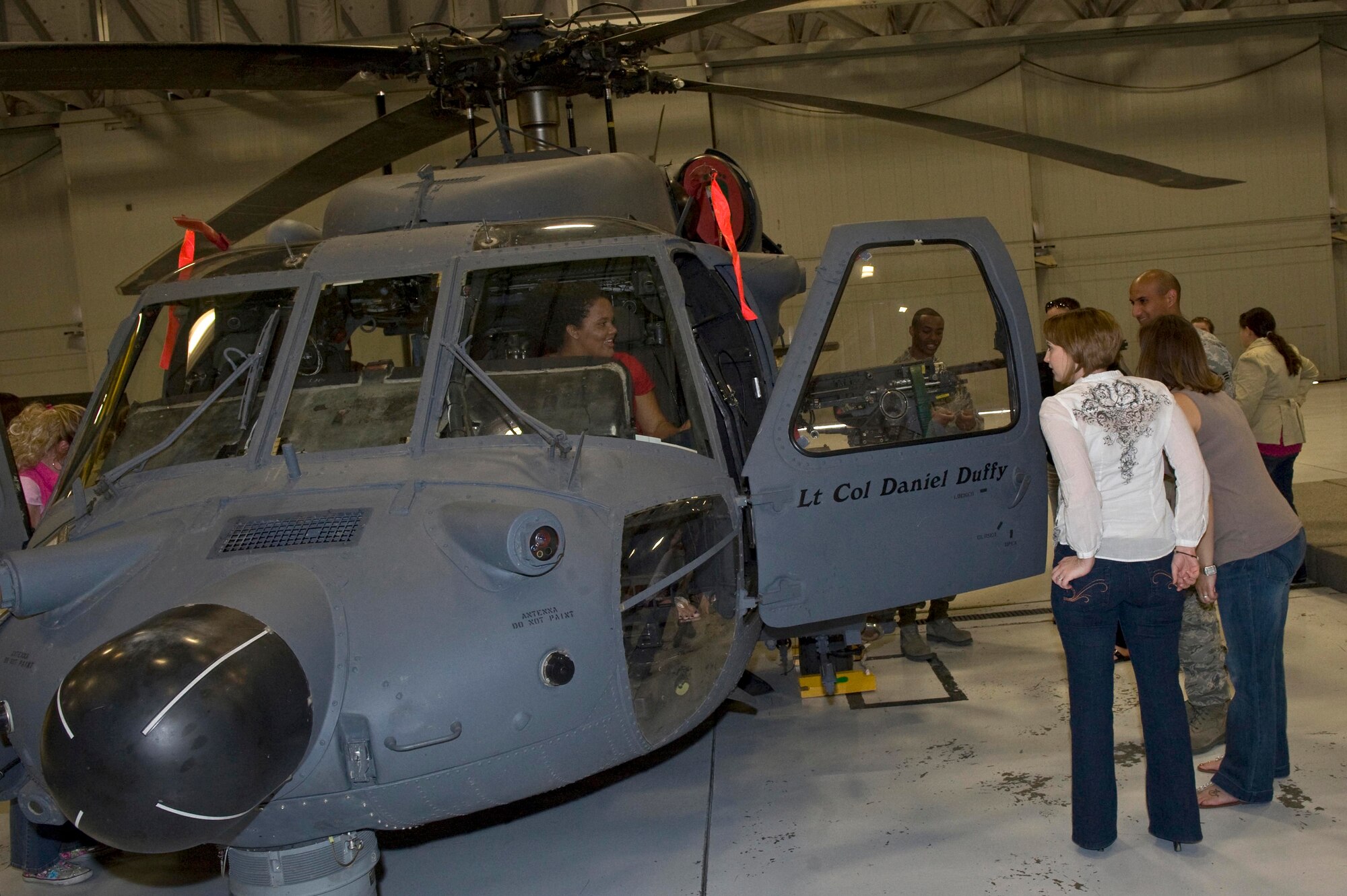 NELLIS AIR FORCE BASE, Nev. --Members from the Key Spouse group gather around a HH-60G Pave Hawk during the Key Spouses quarterly event at the 763rd Maintenance Squadrons hanger April 8. Key Spouses is a base wide organization that allows spouses the opportunity to learn about different aspects of the Air Force while their husbands and wives are deployed. ( U.S Air Force Photo by Airman 1st Class Daniel Hughes)