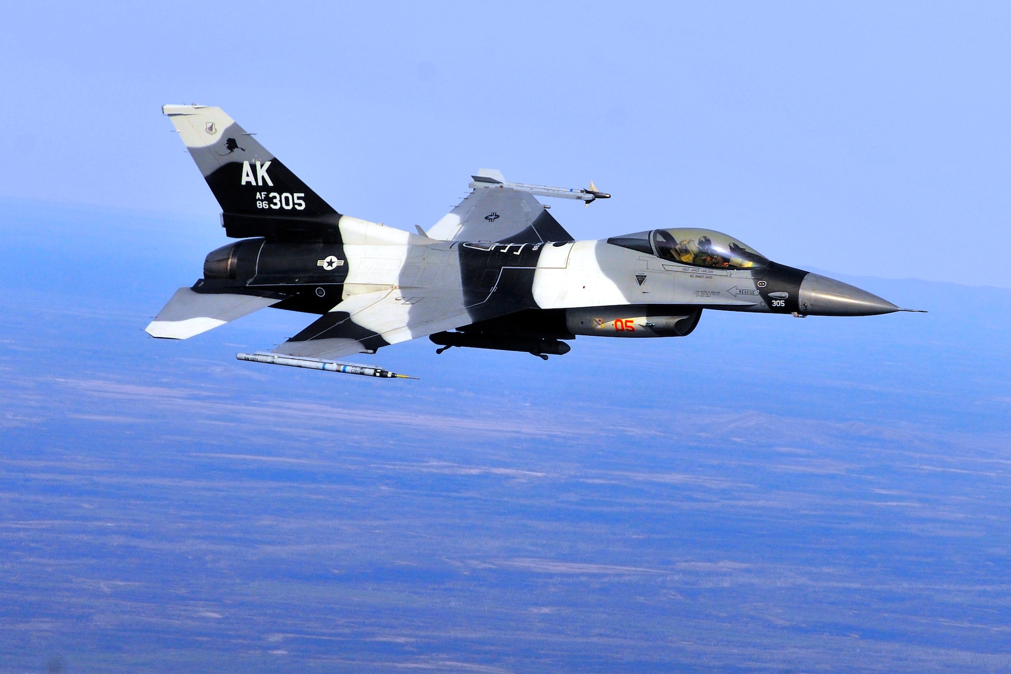 Maj. Mark Schmidt pilots an F-16 Fighting Falcon during RED FLAG-Alaska 11-1 April 29, 2011, Eielson Air Force Base, Alaska. RF-A provides unique opportunities to integrate various forces into joint, coalition and bilateral training from simulated forward operating bases. Major Schmidt is an F-16 pilot assigned to the 18th Aggressors Squadron. (U.S. Air Force photo/Staff Sgt. Christopher Boitz)