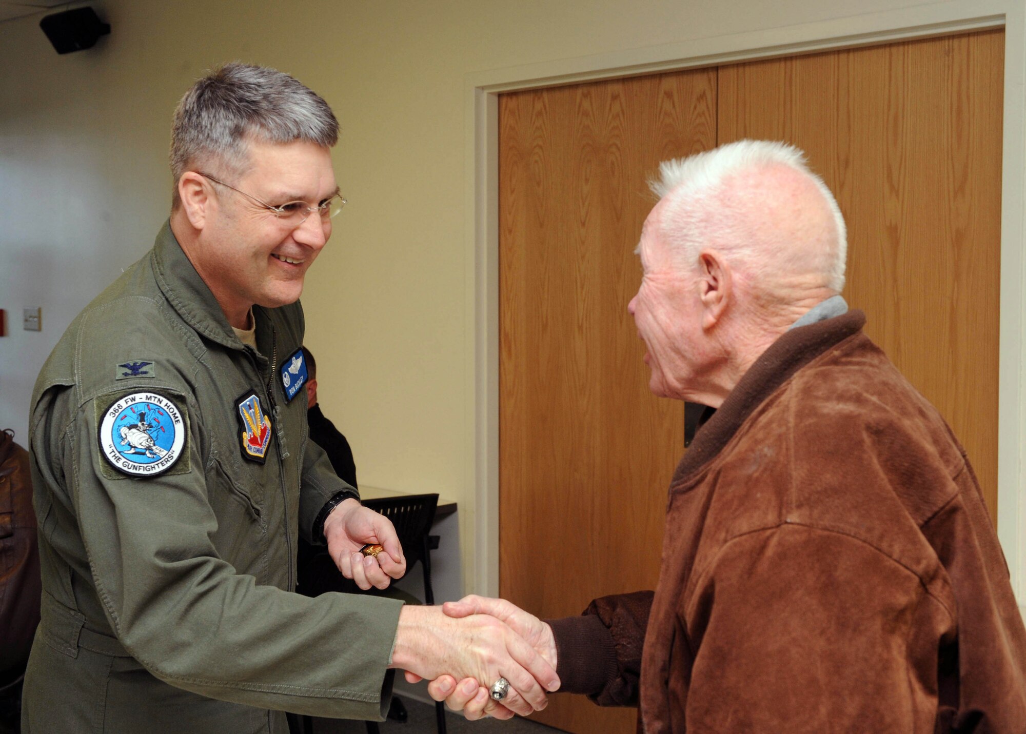 MOUNTAIN HOME AIR FORCE BASE, Idaho – Col. Ron Buckley, 366th Fighter Wing commander, coins Ken Virden, 366th Aircraft Maintenance Unit honorary commander, during the 366th Medical Group honorary commanders tour at the base hospital April 22. The honorary commanders program is a wing-level program that pairs civic leaders with squadron, group and wing leaders to enhance the relationships between local communities and the base. (U.S. Air Force photo by Senior Airman Debbie Lockhart)