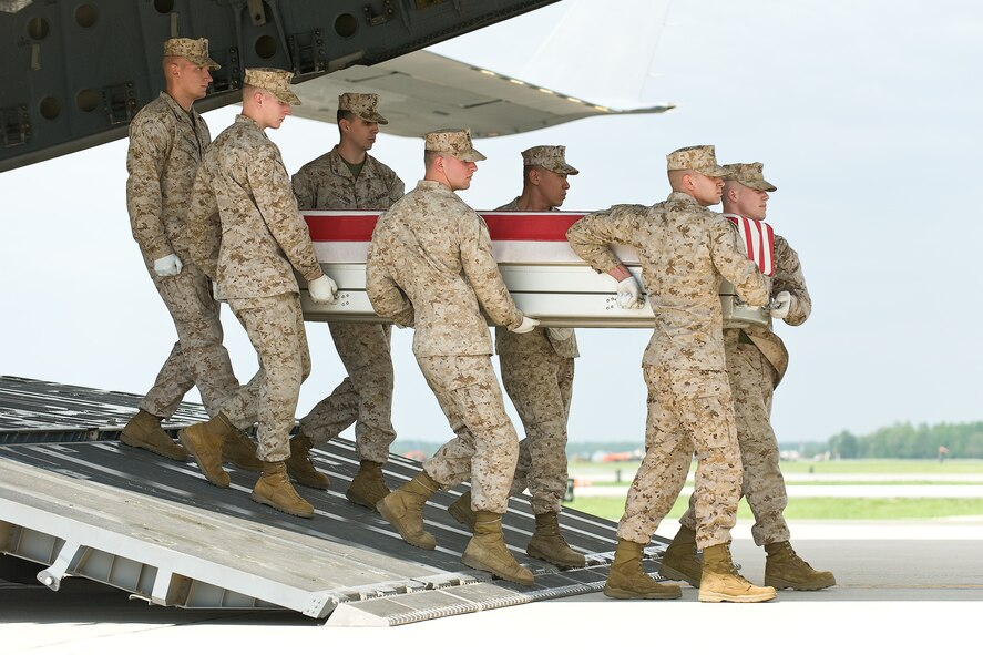 A U.S. Marine Corps carry team transfers the remains of Marine Cpl. Adam D. Jones, of Germantown, Ohio, at Dover Air Force Base, Del., April 29, 2011. Jones was assigned to the 3rd Battalion, 2nd Marine Division, II Marine Expeditionary Force, Camp Lejeune, N.C. (U.S. Air Force photo/Roland Balik)