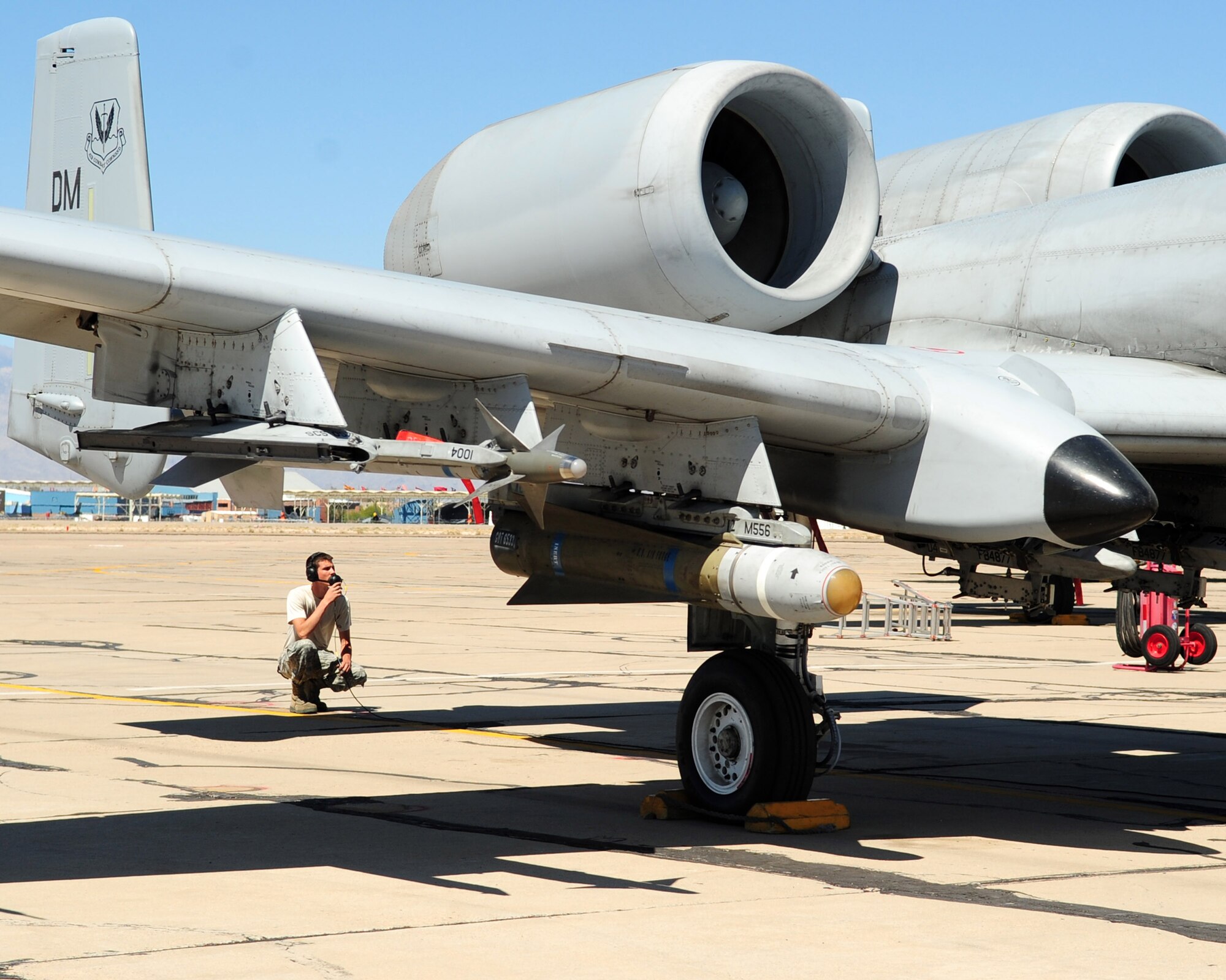 TUCSON, Ariz. - Senior Airman Bradley Luke, a crew chief from the 355th Aircraft Maintenance Squadron, stands by as the an A-10 pilot performs pre-flight operations checks on the flight line at the Tucson International Airport here April 27. D-M closed its runway in March for routine maintenance resulting in the base’s flying missions operating out of Tucson International Airport and various other locations. (U.S. Air Force photo/Airman 1st Class Jerilyn Quintanilla) 