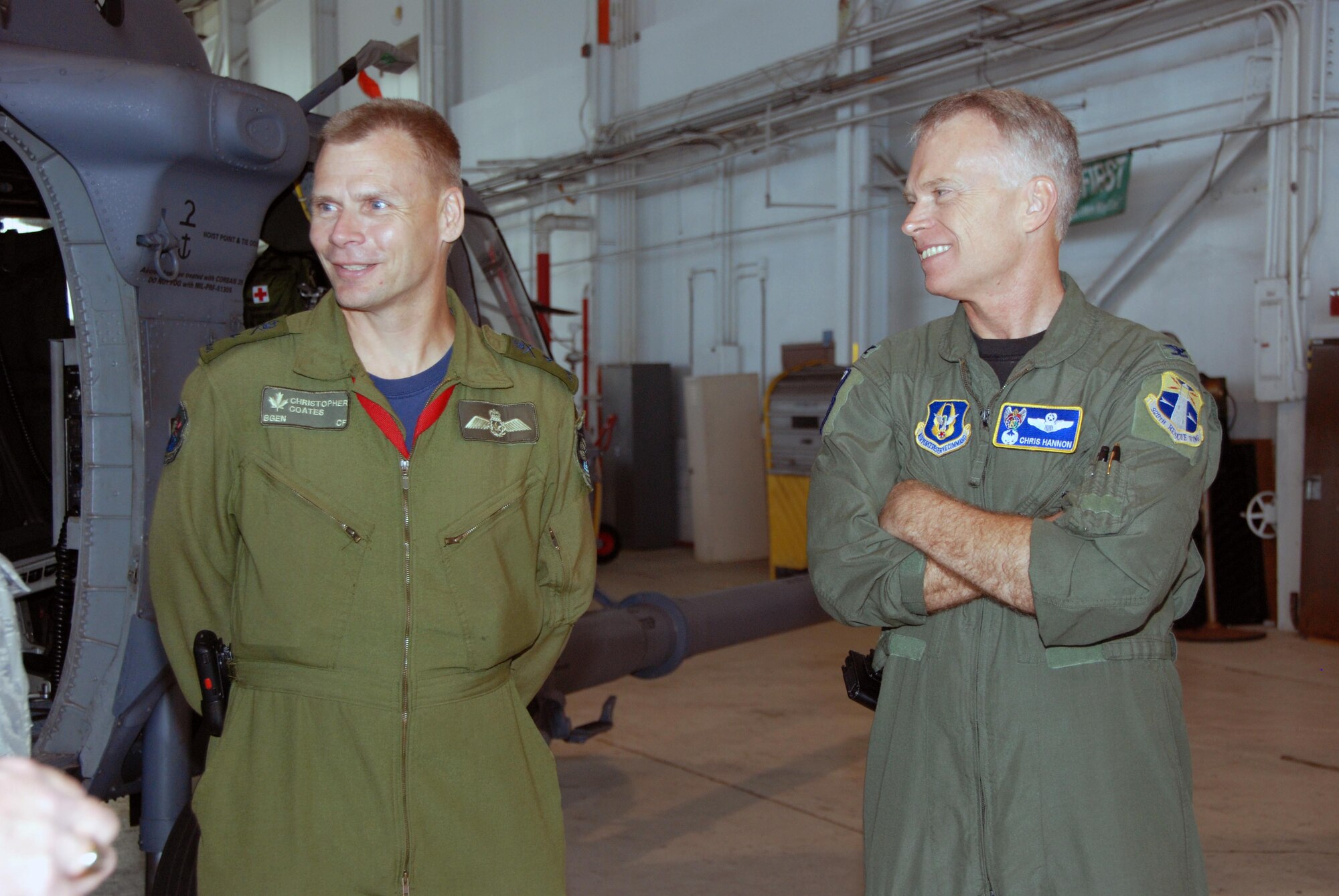 Brig. Gen. Christopher Coates, Continental  U.S. NORAD Region deputy commander and Col. Chris Hannon, 920th Rescue Wing director of operations, discuss the capabilities of the HH-60G helicopter during a tour of the 920th Rescue Wing at Patrick AFB, Fla., April 28. (U.S. Air Force photo by: Capt. Jared Scott)