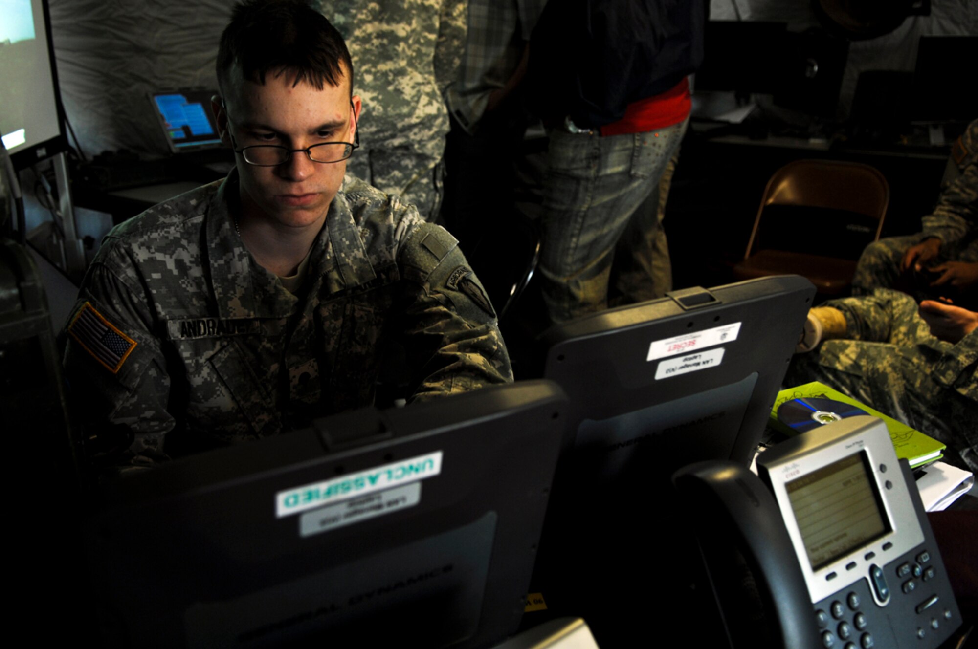 JOINT BASE ELMENDORF-RICHARDSON, Alaska -- Spc. Aaron Andrade, 4th Brigade Combat Team (Airborne) 25th Infantry Division, works on a computer system during the digital exercise here, Apil 18.  JBER Soldiers participated in a two week long DIGEX where they established and maintained a live network in preparations for upcoming field training exercise and deployments. (Photo byAirman 1st Class Jack Sanders/JBER PA)
