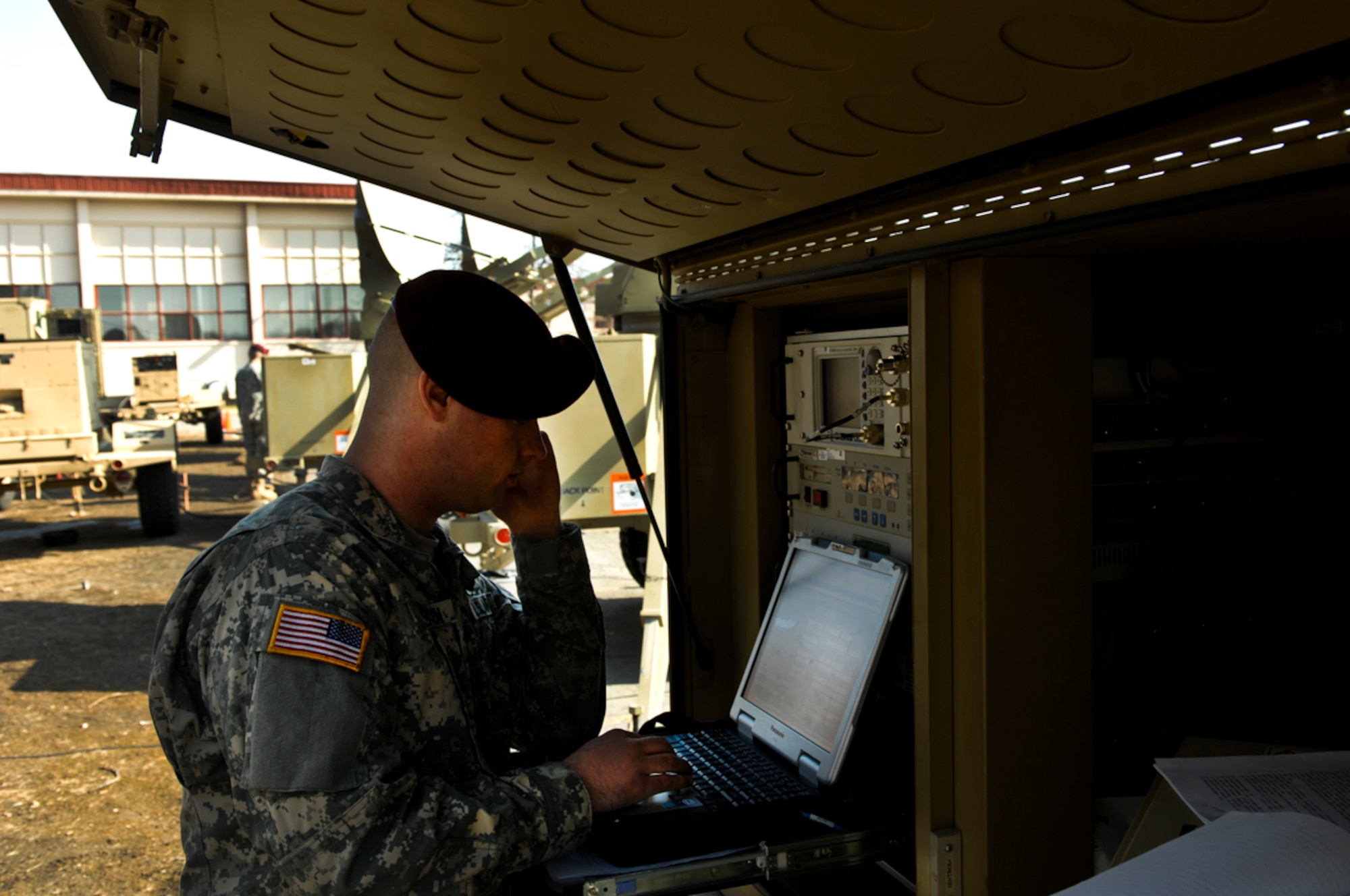 JOINT BASE ELMENDORF-RICHARDSON, Alaska --Spc. Paul Bracken, 4th Brigade Combat Team (Airborne), 25th Infantry Division, talks to a technician from Fort Gordon, Ga., to work out a bug in the system during a digital exercise, April 18. Signal Soldiers participated in a two week DIGEX where they established and maintained a live network in preparation for upcoming field training exercises and to maintain deployment readiness. (Photo by Airman 1st Class Jack Sanders/JBER PA)