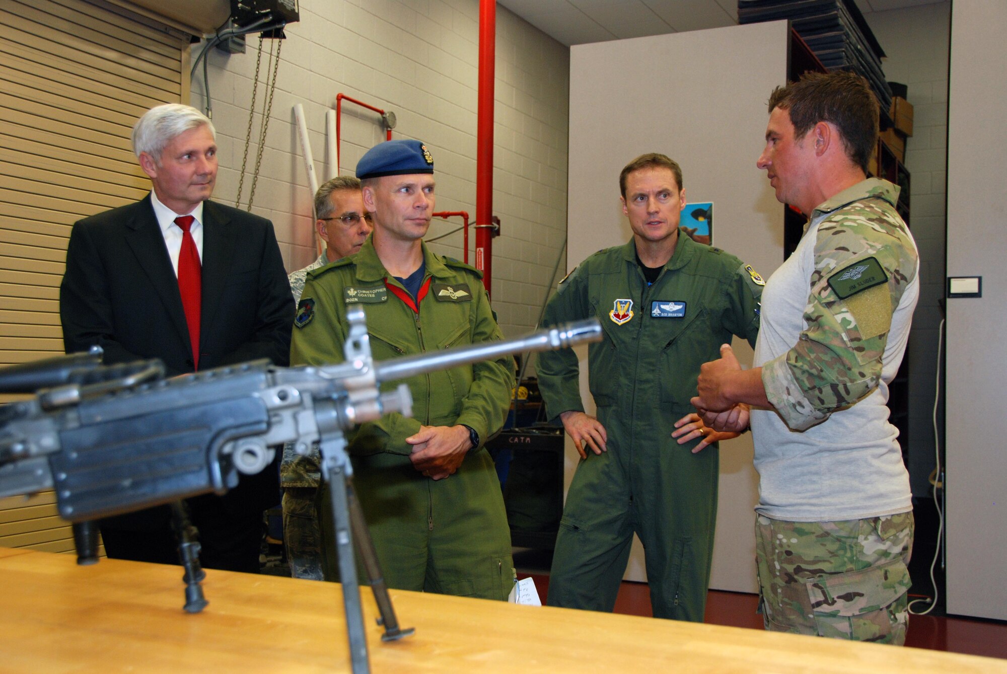 Kent Clark, Defense Appropriations Director and National Security Advisor for Congressman C.W. Bill Young, Brig. Gen. Christopher Coates, Continental  U.S. North American Region deputy commander, and Brig. Gen. Robert Branyon, 1st Air Force vice commander,  listen April 28 as Capt. Jim Sluder, 920th Rescue Wing combat rescue officer at Patrick AFB, Fla., discusses combat weapons used during  search and rescue operations. (U.S. Air Force photo by: Capt. Jared Scott)