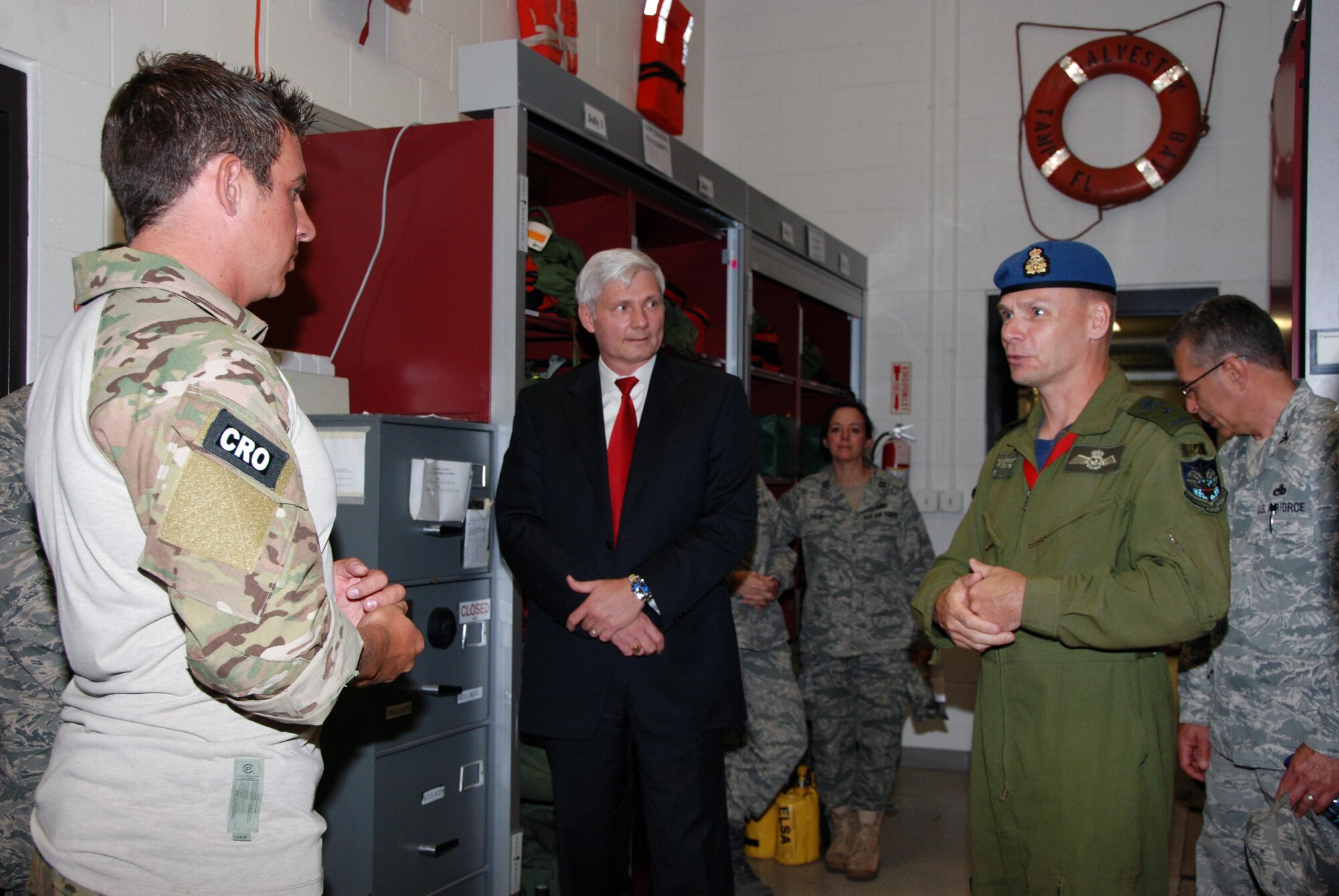 Capt. Jim Sluder (left), 920th Rescue Wing combat rescue officer at Patrick AFB, Fla.,  briefs Kent Clark, Defense Appropriations Director and National Security Advisor for Congressman C.W. Bill Young, and Brig. Gen. Christopher Coates, Continental  U.S. NORAD Region deputy commander, about extraction devices used for search and rescue.  (U.S. Air Force photo by: Capt. Jared Scott)