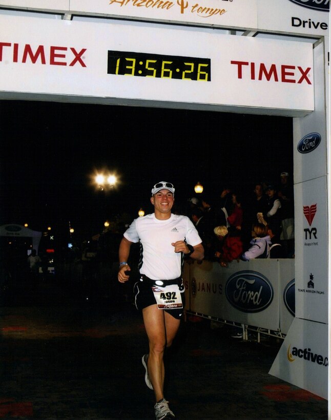 Tech. Sgt. Joe Bello of The USAF Band Ceremonial Brass crosses the finish line at the 2010 Arizona Ironman Triathlon.