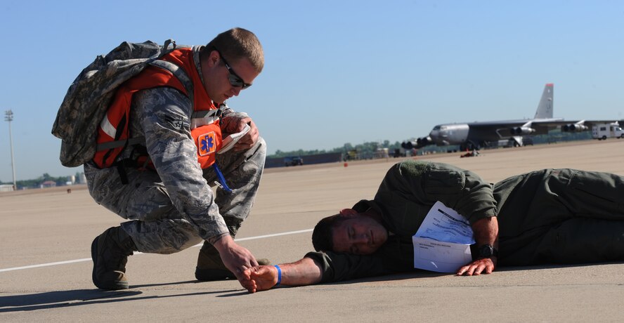 An emergency responder checks an Emergency Tracking System Tag on an Airman acting as an injured pilot during the Major Accident Response Exercise on Barksdale Air Force Base, La., April 29. The EMTRAC System allows hospitals in the local area and first responders to tag, scan and track injured victims. The tags provide the patient's current medical data and which hospital they're going to. (U.S. Air Force photo/Airman 1st Class Micaiah Anthony)(RELEASED)
