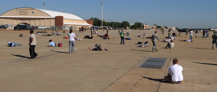 Volunteer Airmen take their places prior to a Major Accident Response Exercise on Barksdale Air Force Base, La., April 29. The volunteers assembled to act as injured or dead spectators after a simulated airplane crash at an air show. The MARE helps emergency personnel on and off base prepare for major accidents. (U.S. Air Force photo/Airman 1st Class Micaiah Anthony)(RELEASED)