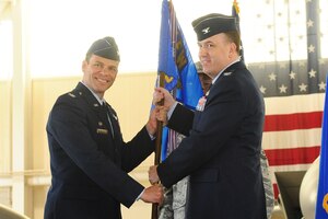 Col. Matthew Molloy, 1st Fighter Wing commander, passes the guidon to Col. Matthew Vanzke, during the 1st Maintenance Group change of command ceremony at Langley Air Force Base, Va., April 29, 2011. Col. Venzke succeeded Col. George Zaniewski as commander of the Group. (U.S. Air Force photo by Staff Sgt. Ashley Hawkins/Released)