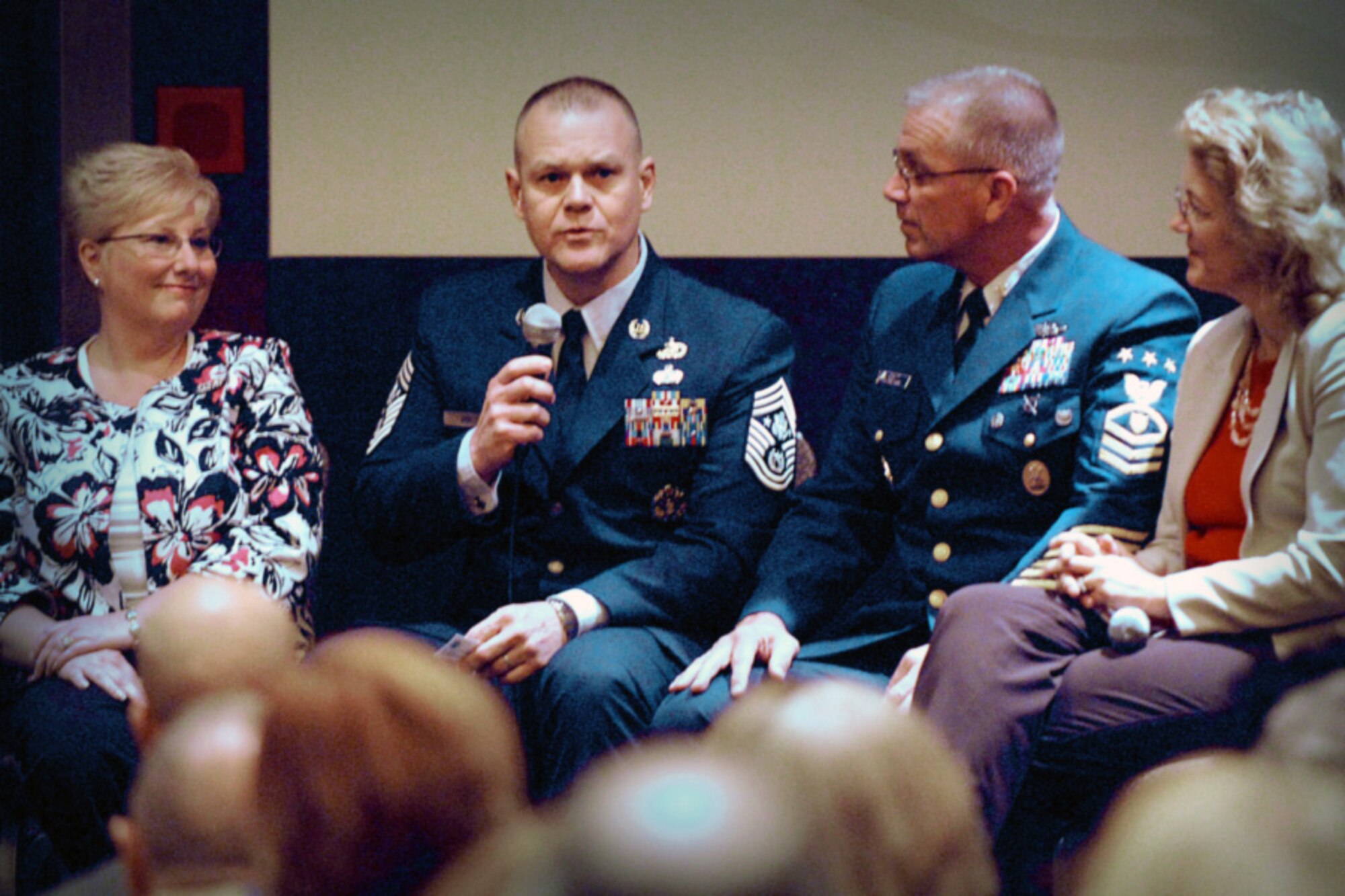 Chief Master Sgt. of the Air Force James A. Roy, with his wife, Paula, by his side, addresses an audience of family support professionals April 28, 2011, during a senior enlisted advisor town hall meeting at the 2011 Family Resilience Conference in Chicago. To his right are Master Chief Petty Officer of the Coast Guard Michael P. Leavitt and his wife, Debbie. (Defense Department photo/Elaine Sanchez)