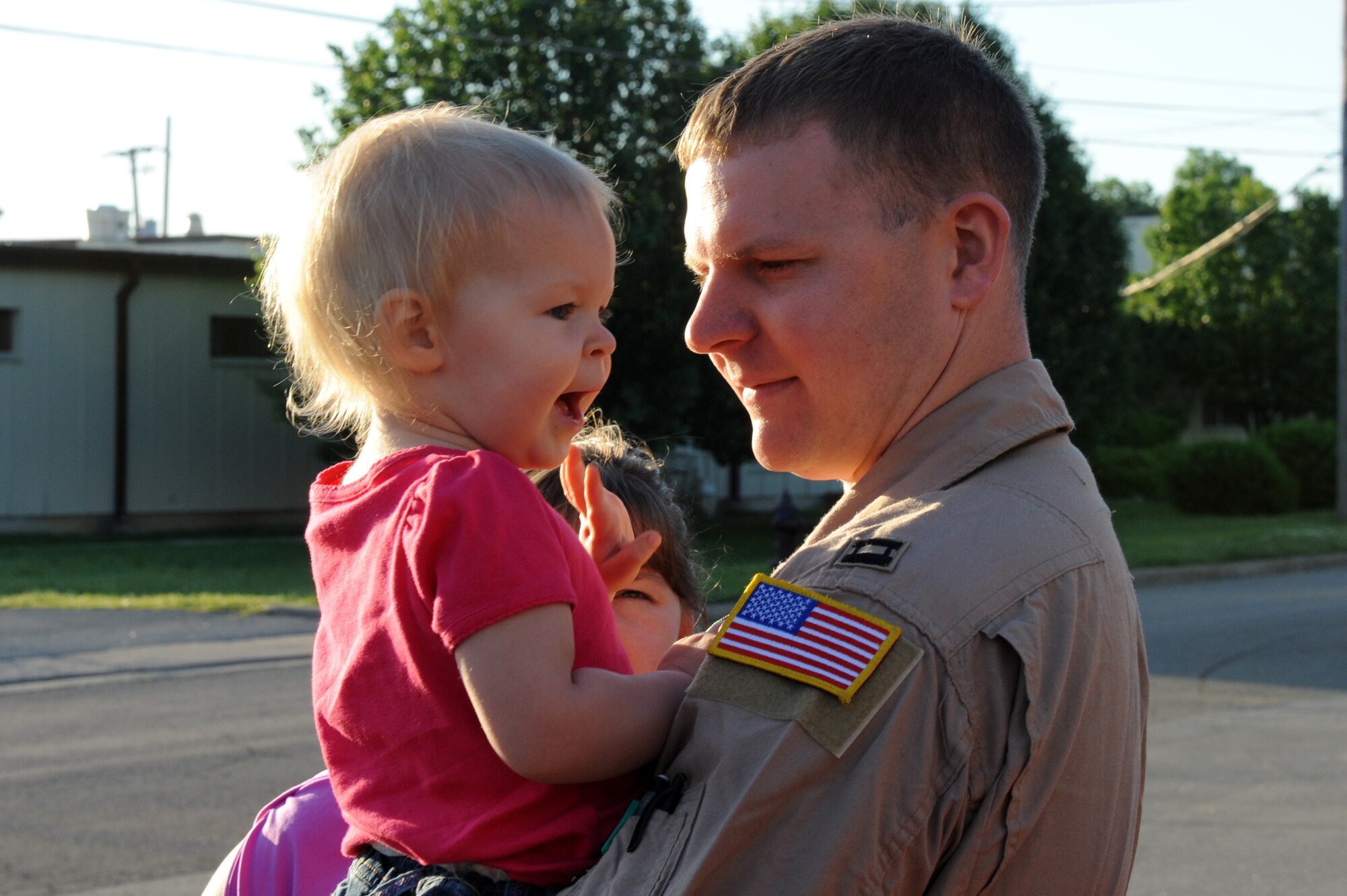 Capt. Daniel Musin, a 50th Airlift Squadron co-pilot, says goodbye to his daughter, Carasya, April 29, 2011, at Little Rock Air Force Base, Ark. 50th AS Airmen left for deployment days after an EF-2 tornado on the Enhanced Fujita Scale (111-135 mph) struck the base at approximately 8 p.m. April 25, damaging aircraft, multiple work centers and more than 100 base housing units. (U.S. Air Force photo by Airman 1st Class Rusty Frank)