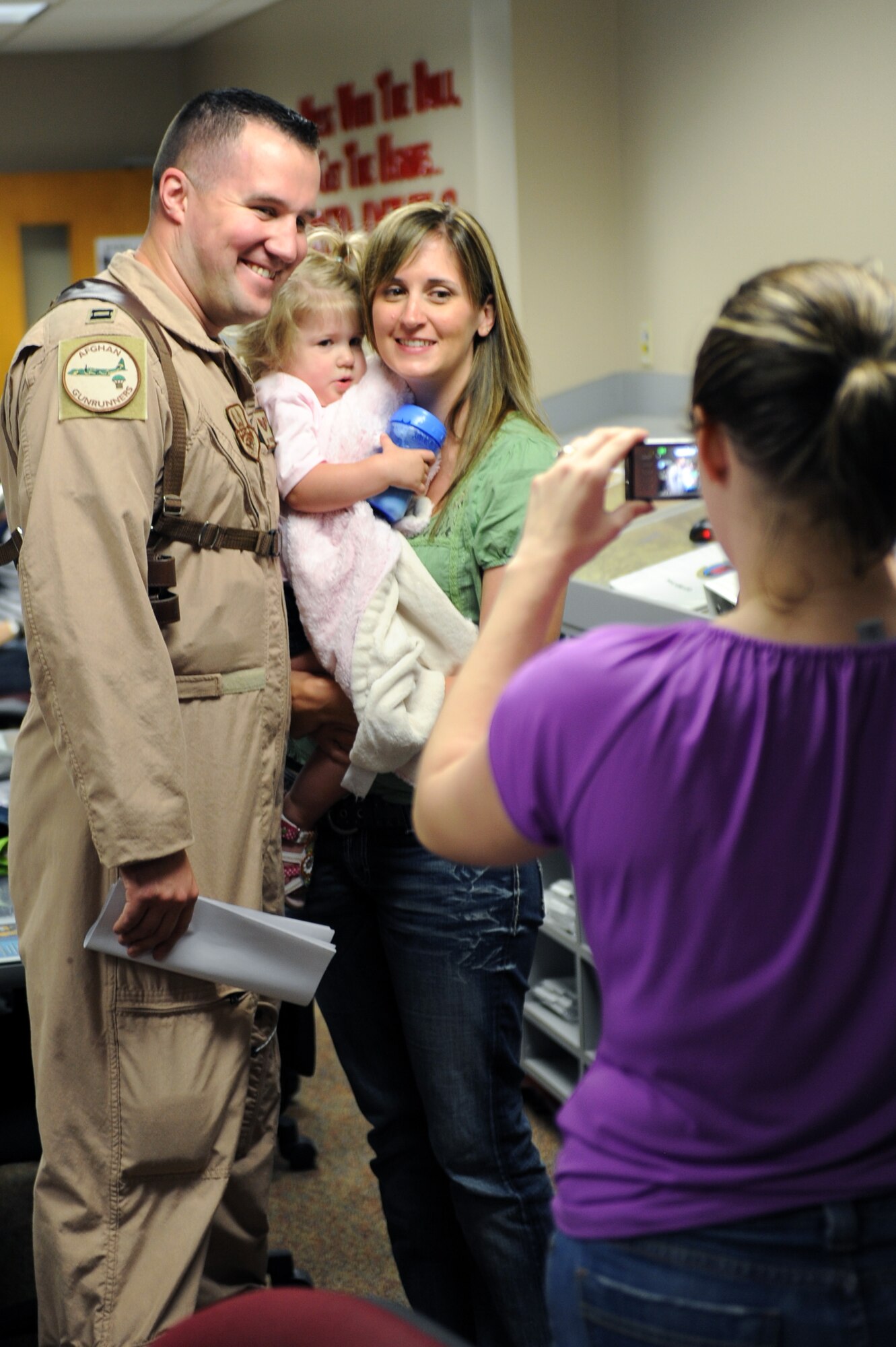 Capt. Matt Howard, a 50th Airlift Squadron navigator, poses for a photo with his family before he deployed April 29, 2011, at Little Rock Air Force Base, Ark. 50th AS Airmen left for deployment days after an EF-2 tornado on the Enhanced Fujita Scale (111-135 mph) struck the base at approximately 8 p.m. April 25, damaging aircraft, multiple work centers and more than 100 base housing units. (U.S. Air Force photo by Airman 1st Class Rusty Frank)