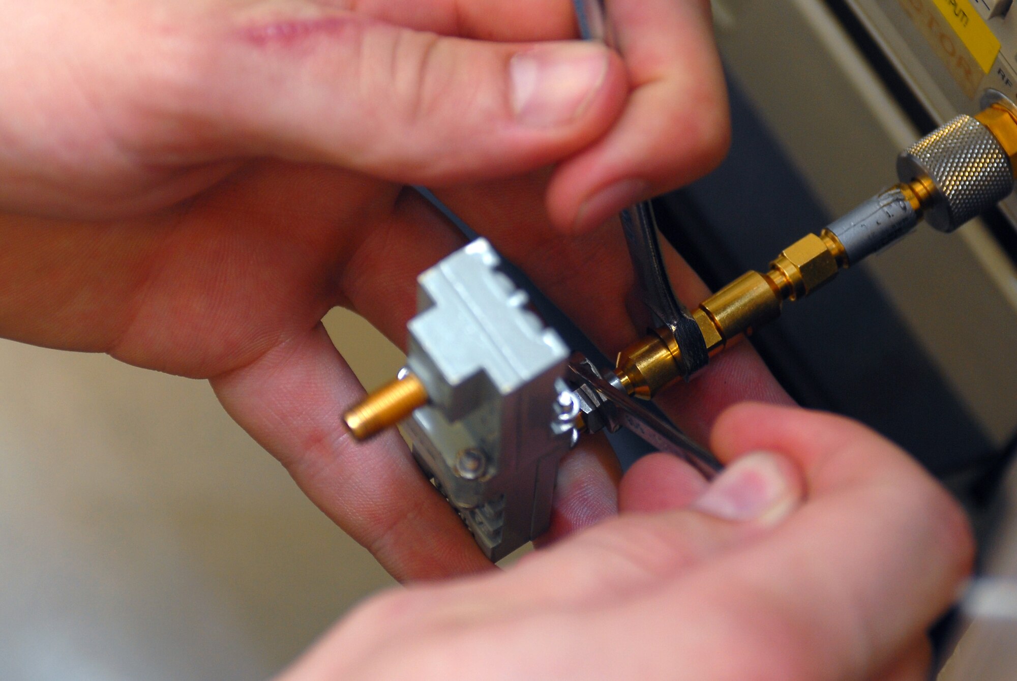 Airman 1st Class Jeffrey Borland, 56th Component Maintenance Squadron Precision Measurement Equipment Laboratory apprentice, prepares to investigate the frequency response characteristics of two K-Band waveguide adapters April 7. These adapters operate at frequencies between 18 and 26.5 billion cycles per second (GHz) which is primarily used for RADAR and satellite communications. (U.S. Air Force photo by Senior Airman Tracie Forte)
