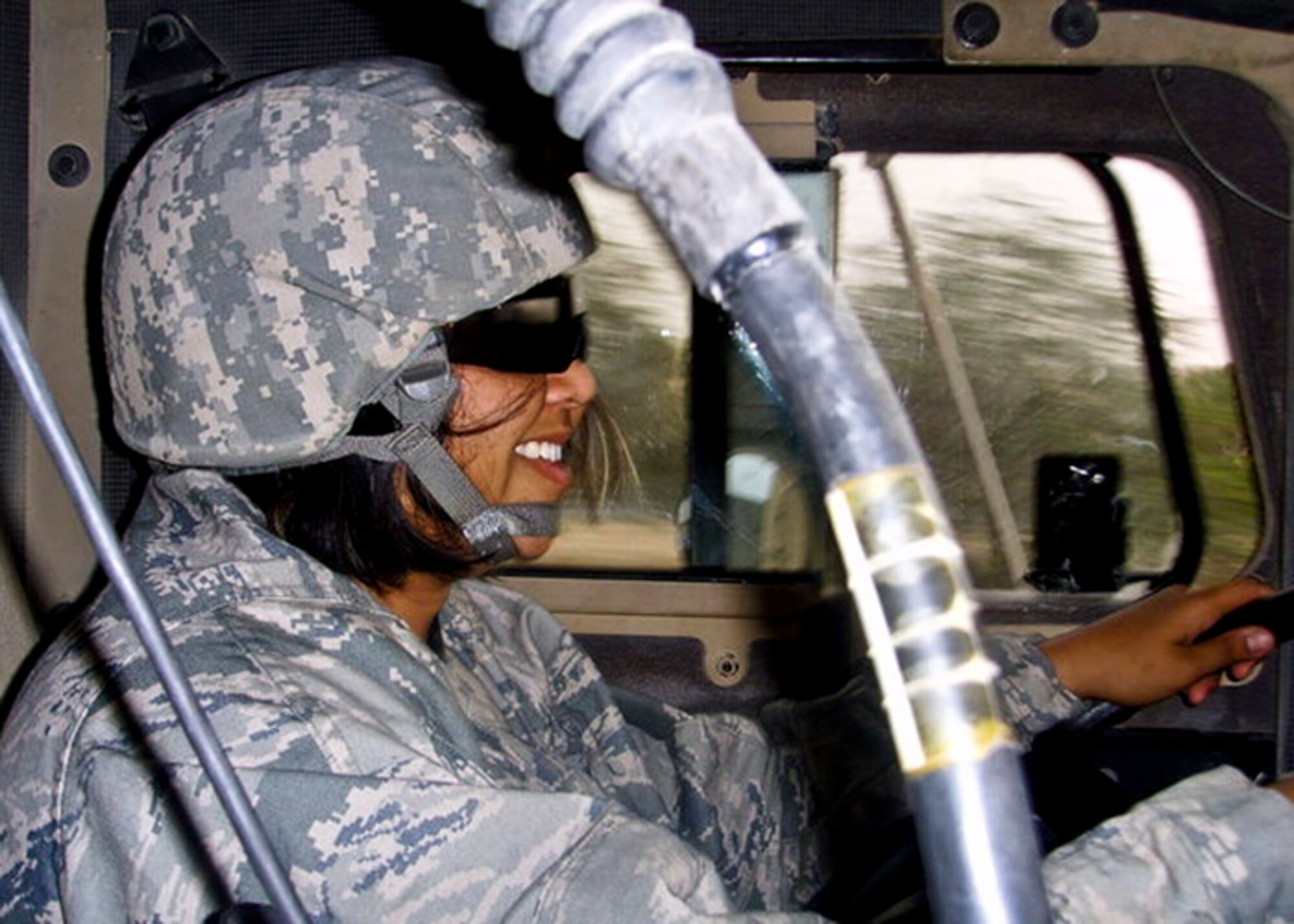 Senior Airman Michelle Wamsley, 96th Logistics Readiness Squadron, drives in a convoy operation during her recent deployment in 2010.  When they deploy, Eglin’s vehicle operators shift gears from bus drivers and dispatchers to “combat truckers” hauling critical cargo in convoys to and from Iraq.  (Courtesy photo)