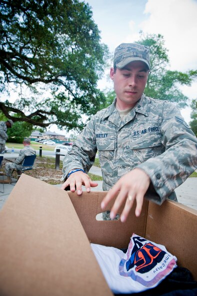 MOODY AIR FORCE BASE, Ga. -- Airman 1st Class Melvin Hartley, 23rd Civil Engineer Squadron heating, ventilating and air conditioning apprentice, fills a box with donated clothing April 28 outside of the Airman and Family Readiness Center. Airman Hartley and other members of the HVAC shop dedicated two days to collect clothes, non-perishable goods, toiletries and children’s toys in response to a series of tornadoes that recently struck areas in North Carolina. All items collected will be personally driven to the Red Cross and The Salvation Army of Fayetteville, N.C. (U.S. Air Force photo/Staff Sgt. Jamal D. Sutter)(RELEASED)