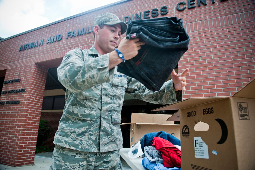 MOODY AIR FORCE BASE, Ga. -- Airman 1st Class Melvin Hartley, 23rd Civil Engineer Squadron heating, ventilating and air conditioning apprentice, sorts through a pile of donated clothing April 28 outside of the Airman and Family Readiness Center. Airman Hartley and other members of the HVAC shop collected donations in response to a series of tornadoes that recently struck areas in North Carolina. (U.S. Air Force photo/Staff Sgt. Jamal D. Sutter)(RELEASED)