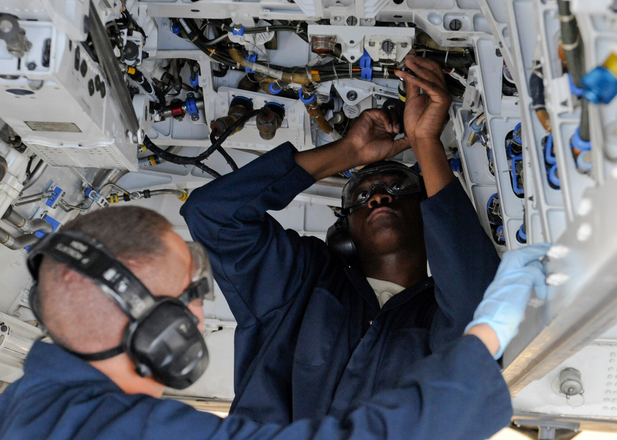 HOLLOMAN AIR FORCE BASE, N.M. -- Staff Sgt. Ernest Fishburne and Senior Airman Patrick Roberts, F-22 Raptor weapons loaders from the 49th Aircraft Maintenance Squadron, configure the main weapons bay for air to ground munitions April 28, 2011, during the 49th Wing’s Operational Readiness Inspection. The purpose of an ORI is to show the Air Combat Command Inspector General Team that Team Holloman can quickly transition from peacetime readiness to a wartime posture. (U.S. Air Force photo by Senior Airman Veronica Stamps/Released)