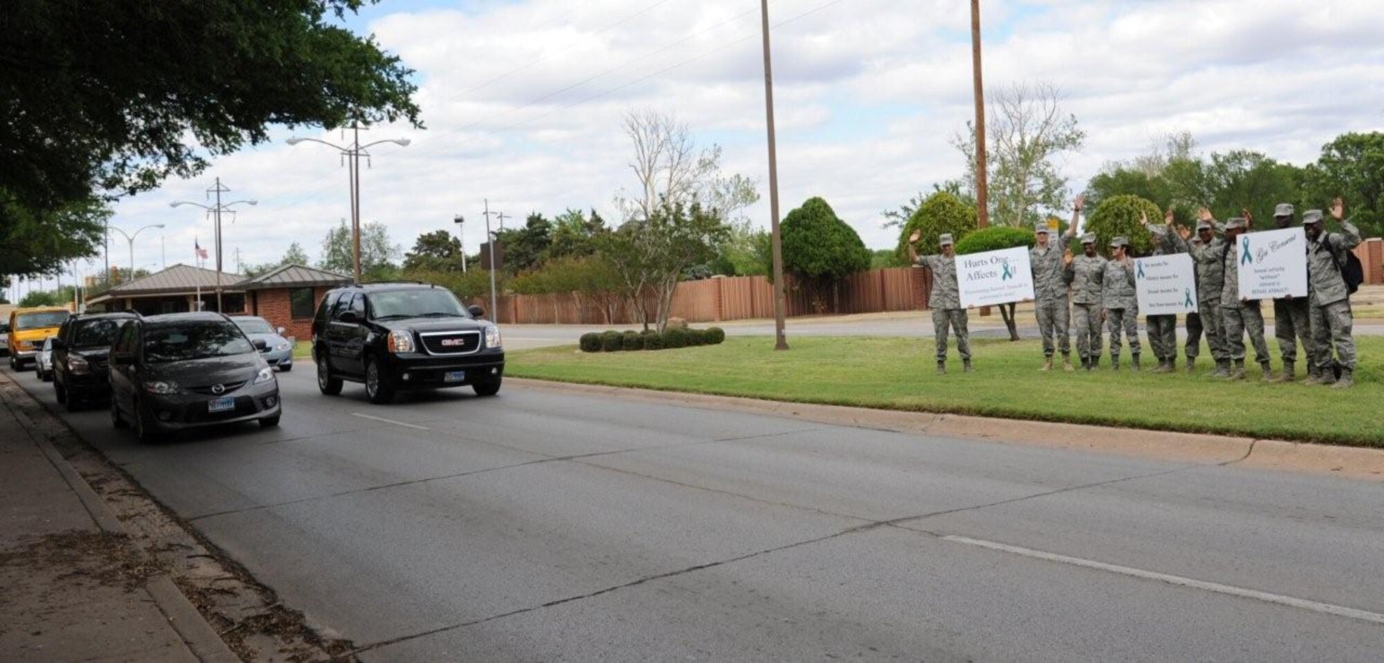 Members of the Students Against Sexual Assault Program finish off Sexual Assault Awareness Month by holding signs with some words of wisdom at the main gate for Sheppard members to see as they leave April 27. SASH members held up signs at all three gates for the last week of SAAM. The program is managed by Staff Sgt. Kathlyn Ruiz 82nd Training Wing Sexual Assault Prevention and Response representative, and meets with Sheppard Airmen in Training the first Wednesday of each month in the Purple Room of the Community Activities Center at 3:30 p.m. (U.S. Air Force photo/Airman 1st Class Adawn Kelsey) 