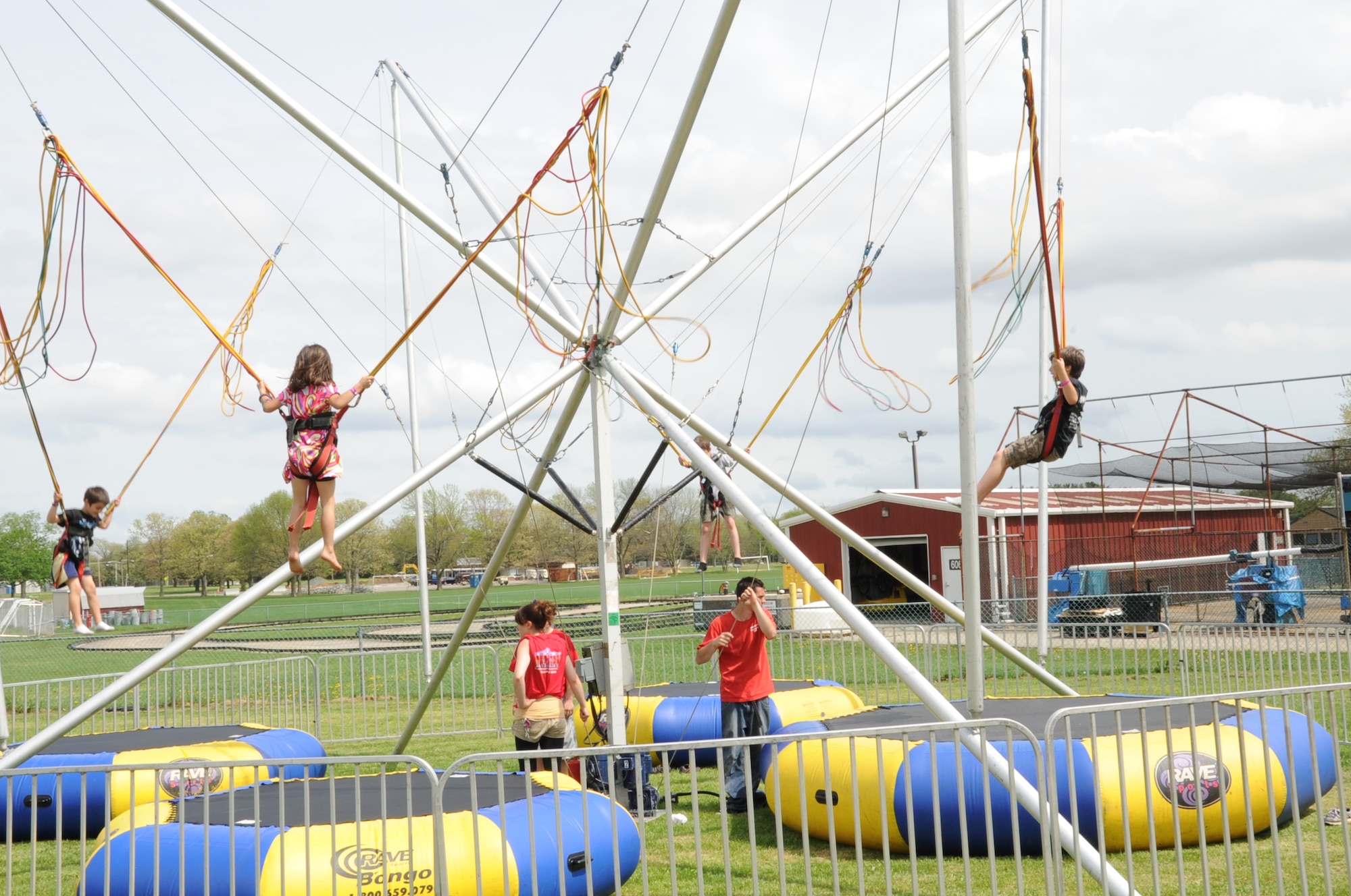Eurobungy staff members work the lines to keep four community youngsters suspended in the air during the Joint Base McGuire-Dix-Lakehurst Family Fun Fest. More than 1,000 members of the community attended this years’ fun fest. (U.S. Air Force photo by Pascual Flores/Released)