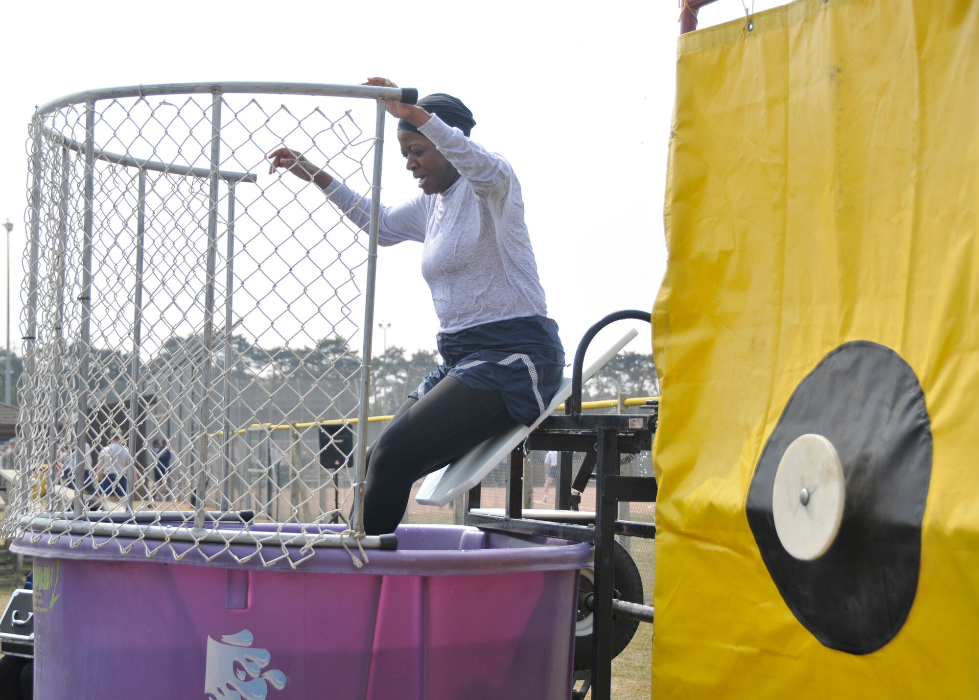 ROYAL AIR FORCE LAKENHEATH, England Chief Master Sgt. Sarita Lathan, 48th Fighter Wing command chief, drops into water in the dunking booth at the softball field during the Wing Sports Day on April 29, 2011. Airmen were given the opportunity to dunk first sergeants, commanders, and other Airmen as a fundraiser for the Top 3 to support various events held on base throughout the year. (U.S. Air Force photo/Senior Airman Tiffany M. Deuel)