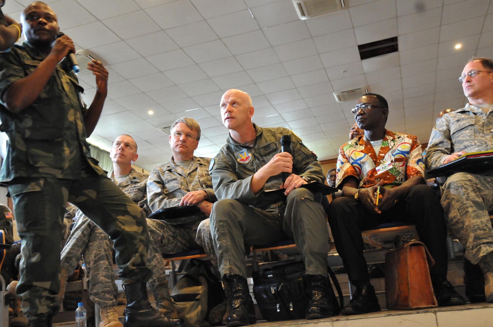 KINSHASA, Democratic Republic of Congo -- A Congolese translator (left) translates a question from Col. Joe Maslar (center), Chief of Aerospace Medicine for the Illinois National Guard's 182nd Airlift Wing, during a Congolesian lead training on tuberculosis at the Centre Superior Militiare Academy here April 28, 2011 as part of MEDLITE 11. MEDLITE 11 is a joint medical exercise focused on aeromedical evacuation, to improve the readiness of U.S. Air Force and DRC personnel. (U.S. Air Force photo by Tech. Sgt. John Orrell)