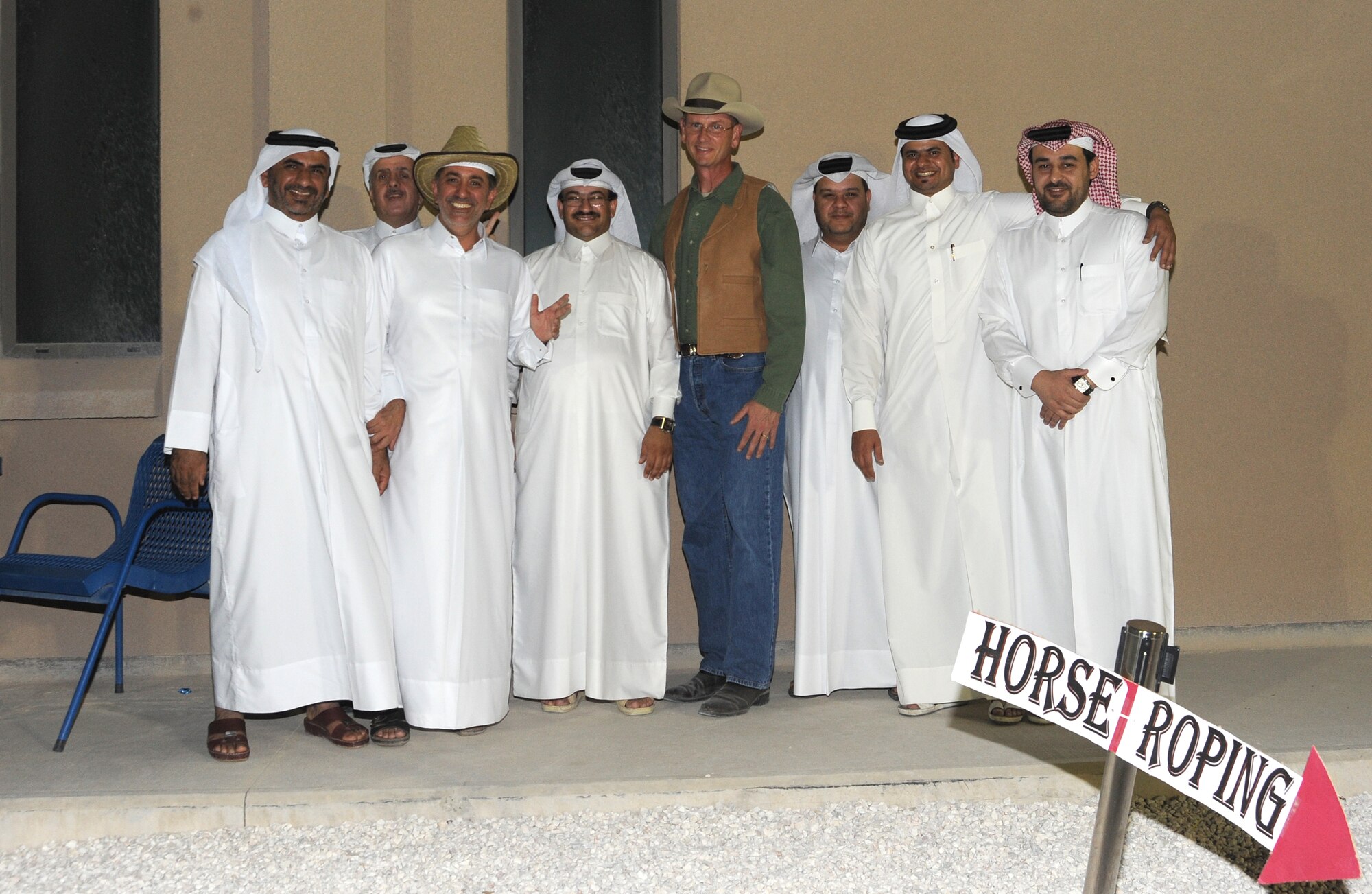 Brig. Gen. Randy Kee, 379th Air Expeditionary Wing commander, gathers with host nationals during at Texas-style barbecue April 27 in Southwest Asia.  The event also included various activities such as horseshoes and lassoing, along with a traditional western meal.  (U.S. Air Force photo/Staff Sgt. Liliana Moreno)
