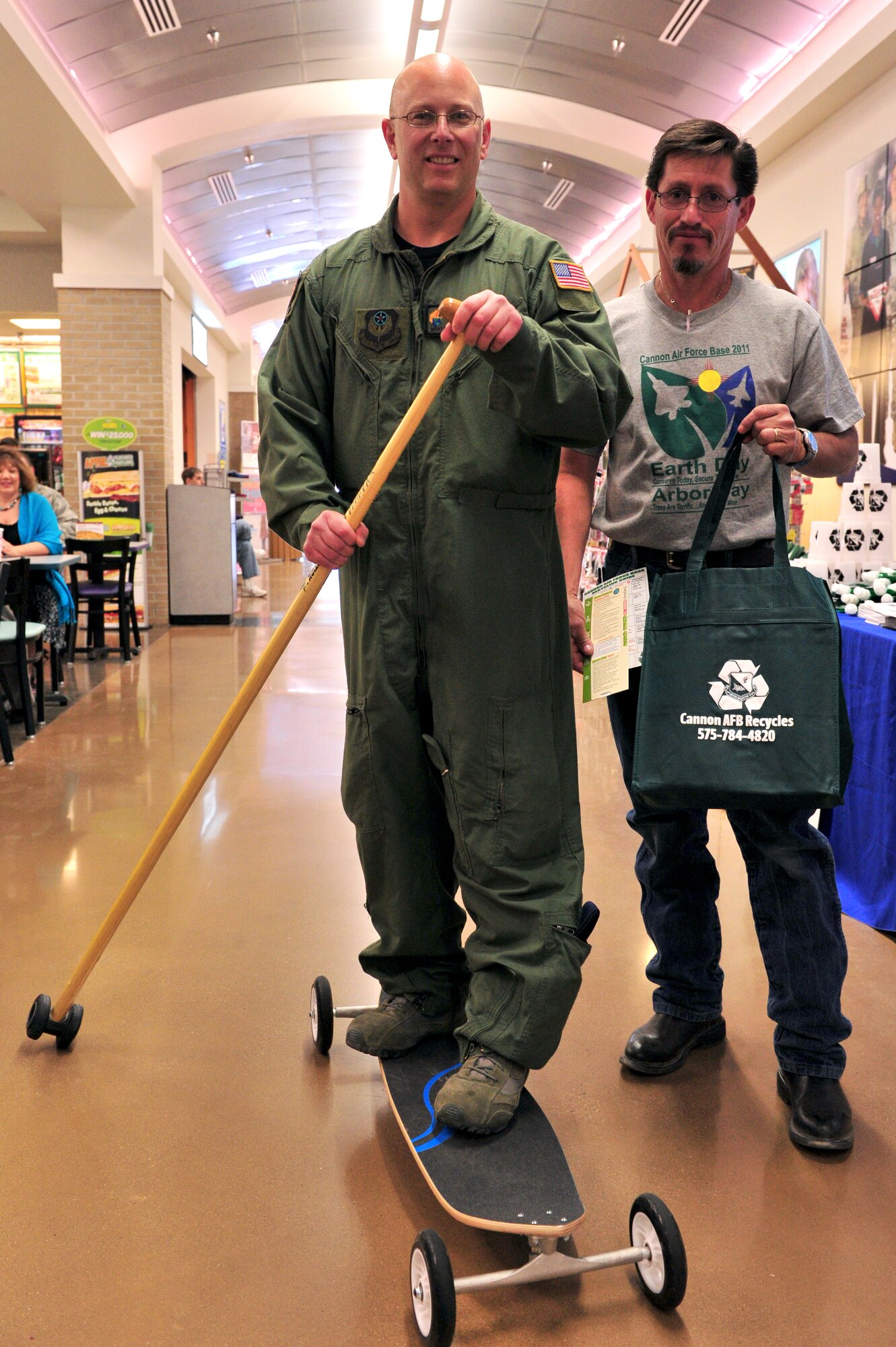 Jake Madril, 27th Special Operations Civil Engineer Squadron, stands with Master Sgt. Davis San Marco, 73rd Special Operations Squadron, and commends his earth-friendly mean of locomotion April 28, 2011. The Asset Management Flight of the 27th Special Operations Civil Engineer Squadron handed out information, reusable cups and souvenirs in support of Earth Day and Arbor Day. (U.S. Air Force photo by Tech. Sgt. Josef Cole)(RELEASED)
