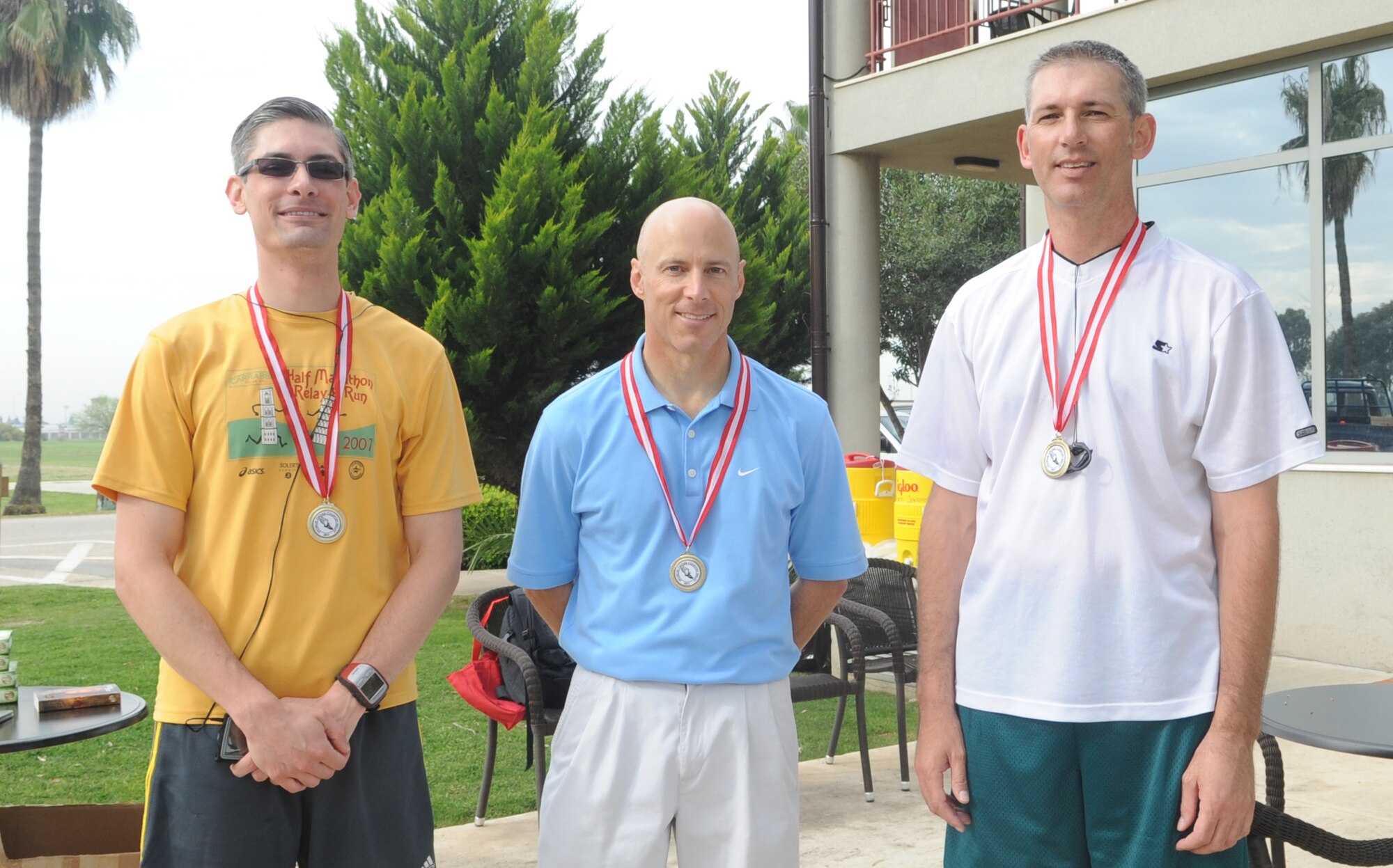 Mr. Jason Livingston, Maj. Thomas Ausherman and Capt. Shane Schmitt, all from the 39th Force Support Squadron, pose for a team photo after participating in “Run to Read,” a 4.2 mile cross-country relay race at Incirlik Air Base, Turkey April 16, 2011. Each relay team consisted of three people and each team member was required to run a 1.4 mile leg of the race.  The purpose of the relay race was to offer the Incirlik community a diverse exercise challenge and promote teamwork.  (U.S. Air Force photo by Tech. Sgt. Valda Wilson/Released)