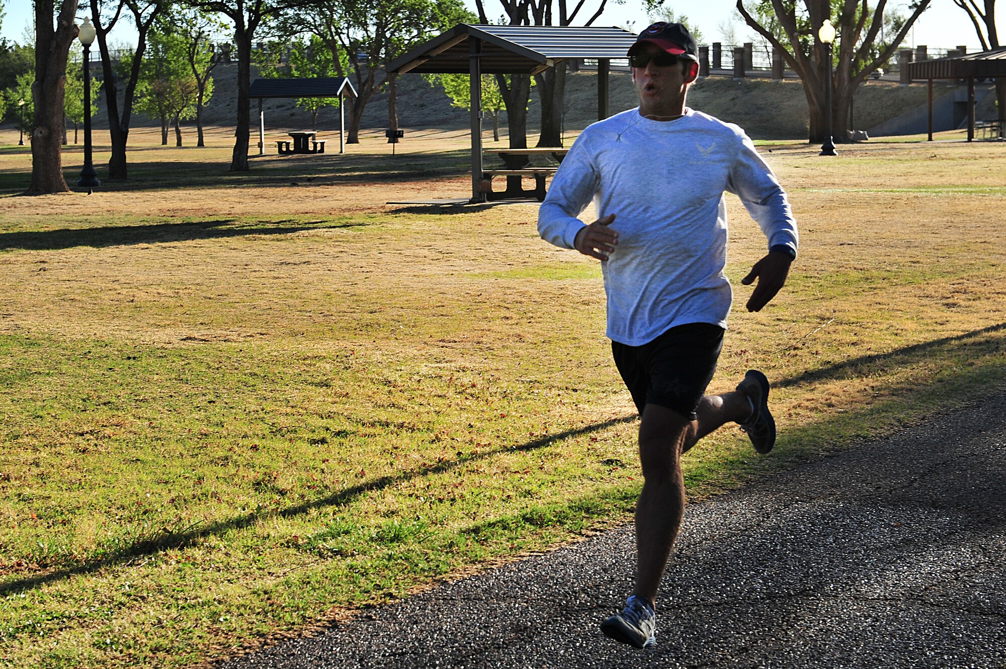 U.S. Air Force Airman 1st Class Jeffrey Swislocki, 27th Special Operations Contracting Squadron, finishes a 5K fun run with a time of 16 minutes, 37 seconds as the sun rises on Cannon Air Force Base, N.M., April 28, 2011. Since he has been stationed at Cannon, Airman Swislocki has won nine 5K races, and he will represent Air Force Special Operations Command in the 2011 Air Force Marathon. (U.S. Air Force photo by Tech. Sgt. Josef Cole)(RELEASED)