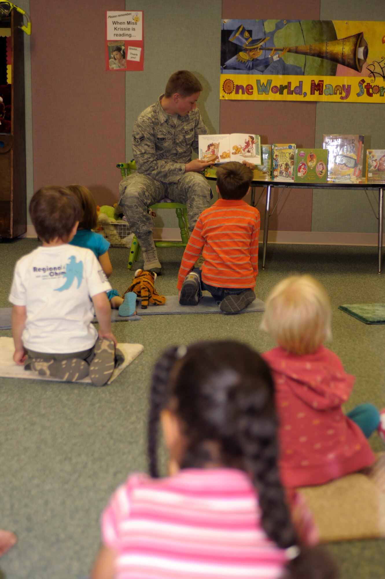 U.S. Air Force Airman 1st Class Nicholas Peters reads a story about taking care of the Earth aloud to children at the Clovis-Carver Public Library in Clovis, N.M., April 28, 2011. Airman Peters is one of the many Cannon Air Force Base Airmen who volunteered in support of Earth Day. (U.S. Air Force photo by Airman Ericka Engblom)(RELEASED)