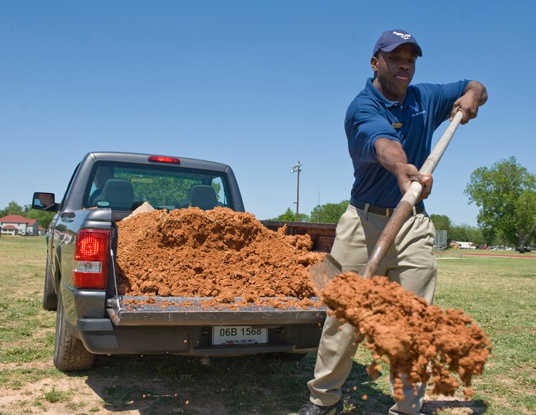 Staff Sgt. Johnnie Powell, 2nd Force Support Squadron NCO in-charge of intramural sports, shovels dirt to level the soccer field outside the fitness center at Barksdale Air Force Base, La., April 28. The fitness center staff performs field maintenance to prepare for the upcoming intramural soccer season. (U.S. Air Force photo/Senior Airman Chad Warren)(RELEASED)