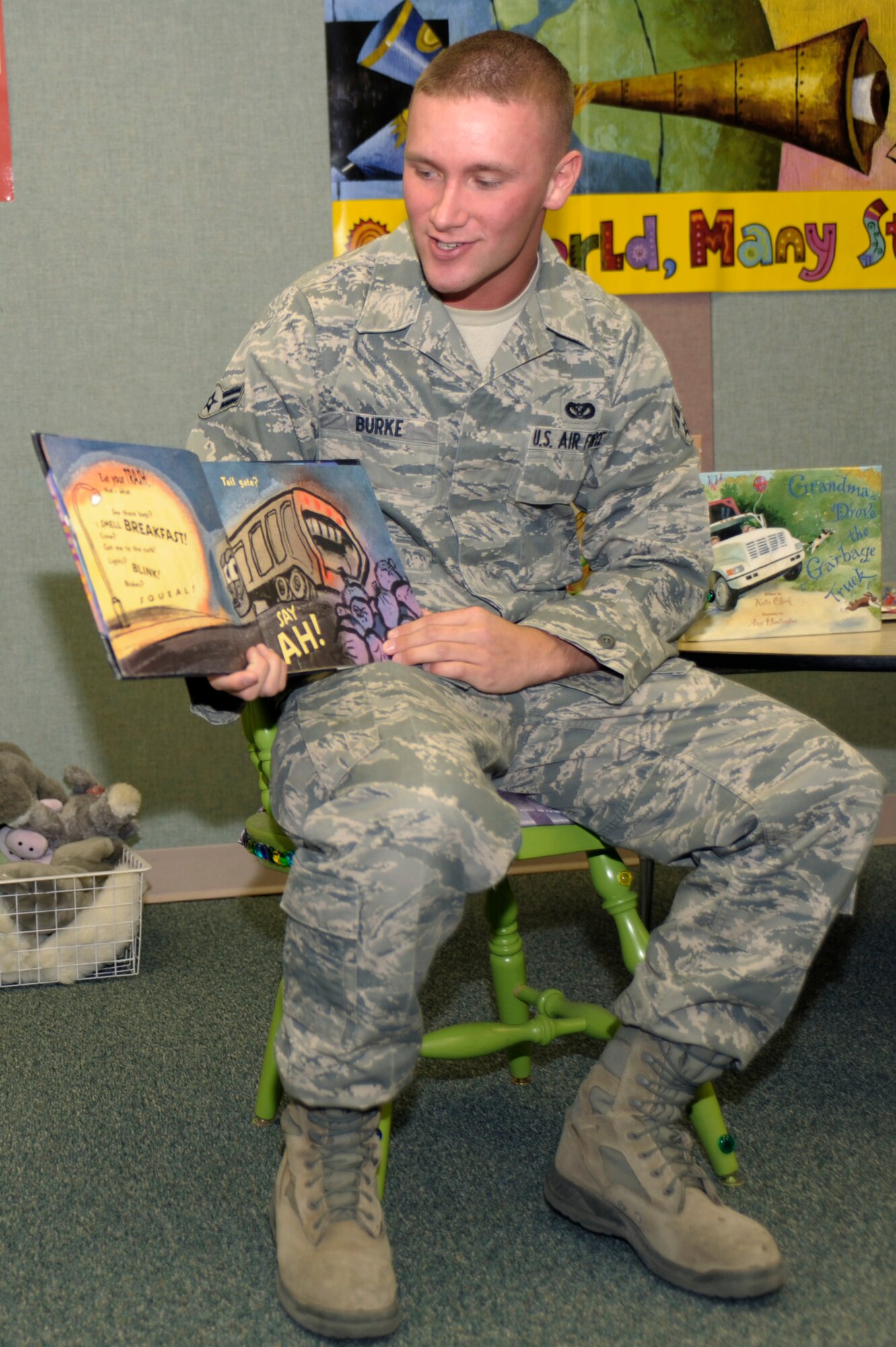 U.S. Air Force Airman 1st Class Jacob Burke reads a story to community children at the Clovis-Carver Public Library in Clovis N.M.,  April 28, 2011. In support of Earth Day, Cannon Air Force Base Airmen taught community children about taking care of the Earth through stories and planting seedlings. (U.S. Air Force photo by Airman Ericka Engblom)(RELEASED)