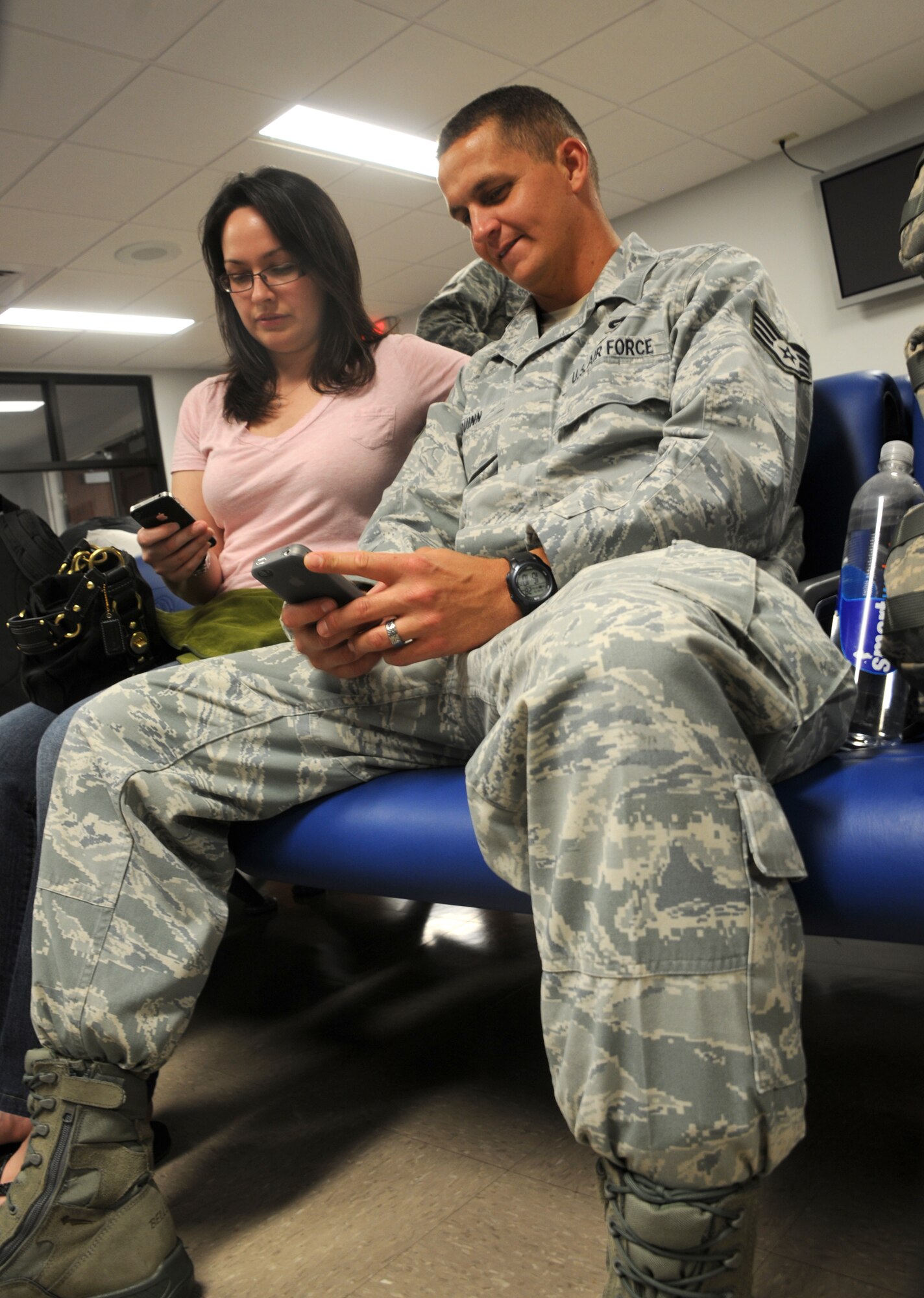 MacDill Air Force Base, Fla. --  Staff Sgt. Robert Quinn and his wife Erin are not ignoring each other moments before he deploys to the East Asia Theater of Operations.  Rather, they use their phones to set up the Skype connection that will keep them connected during the months Robert is away.  The Quinns and other families with the 927th Air Refueling Wing recently said good-bye to their loved ones as the Airmen departed on a deployment. 