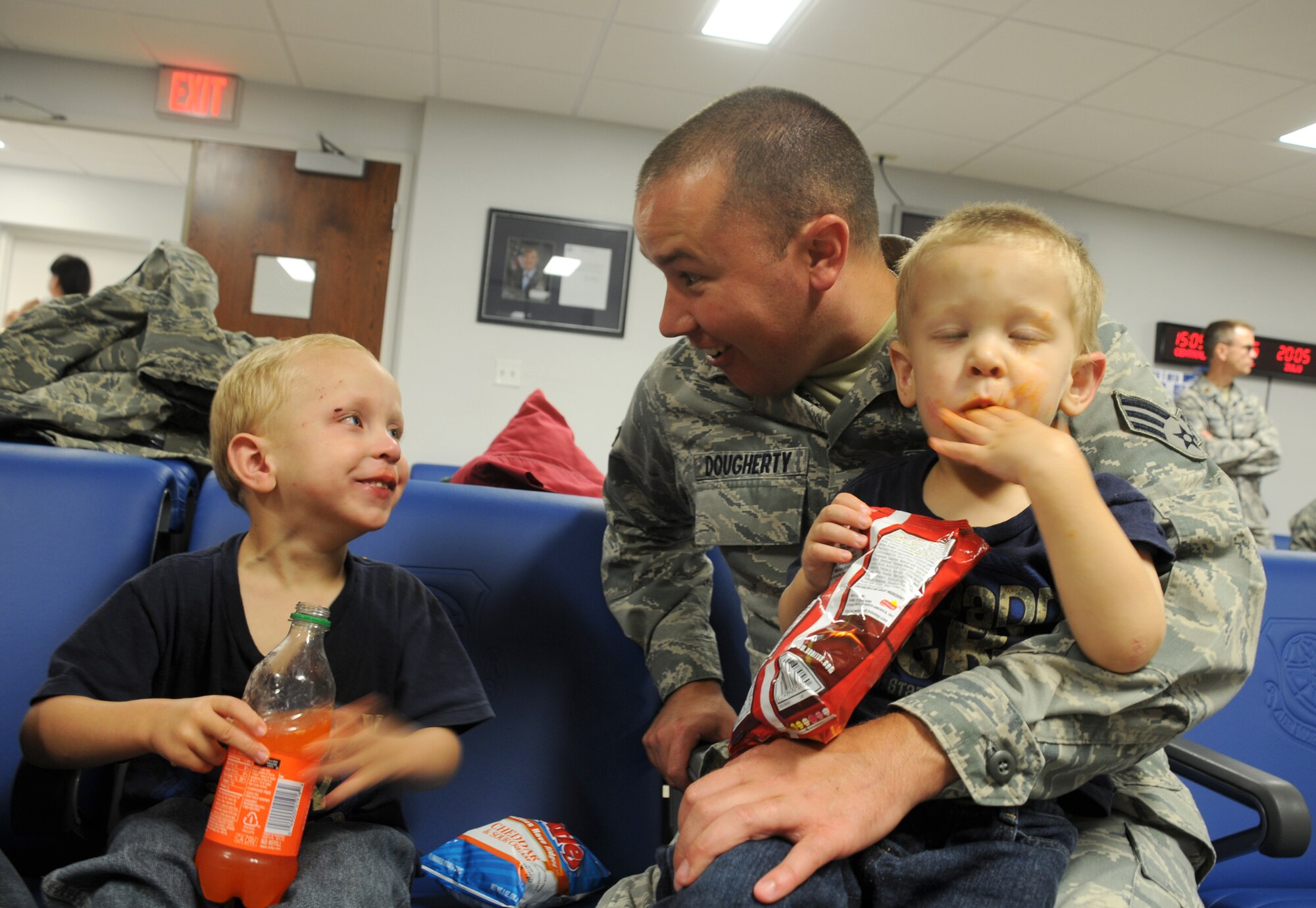 MacDill Air Force Base, Fla. --  Senior Airman Robert Dougherty, a reservist with the 927th Air Refueling Wing here, sits with his two boys; Logan, 4, and Zack, 3, before deploying to the East Asia Theater of Operations.  Dougherty and other reservists tasked with the deployment left their families and jobs in the Tampa community to serve their country overseas. 