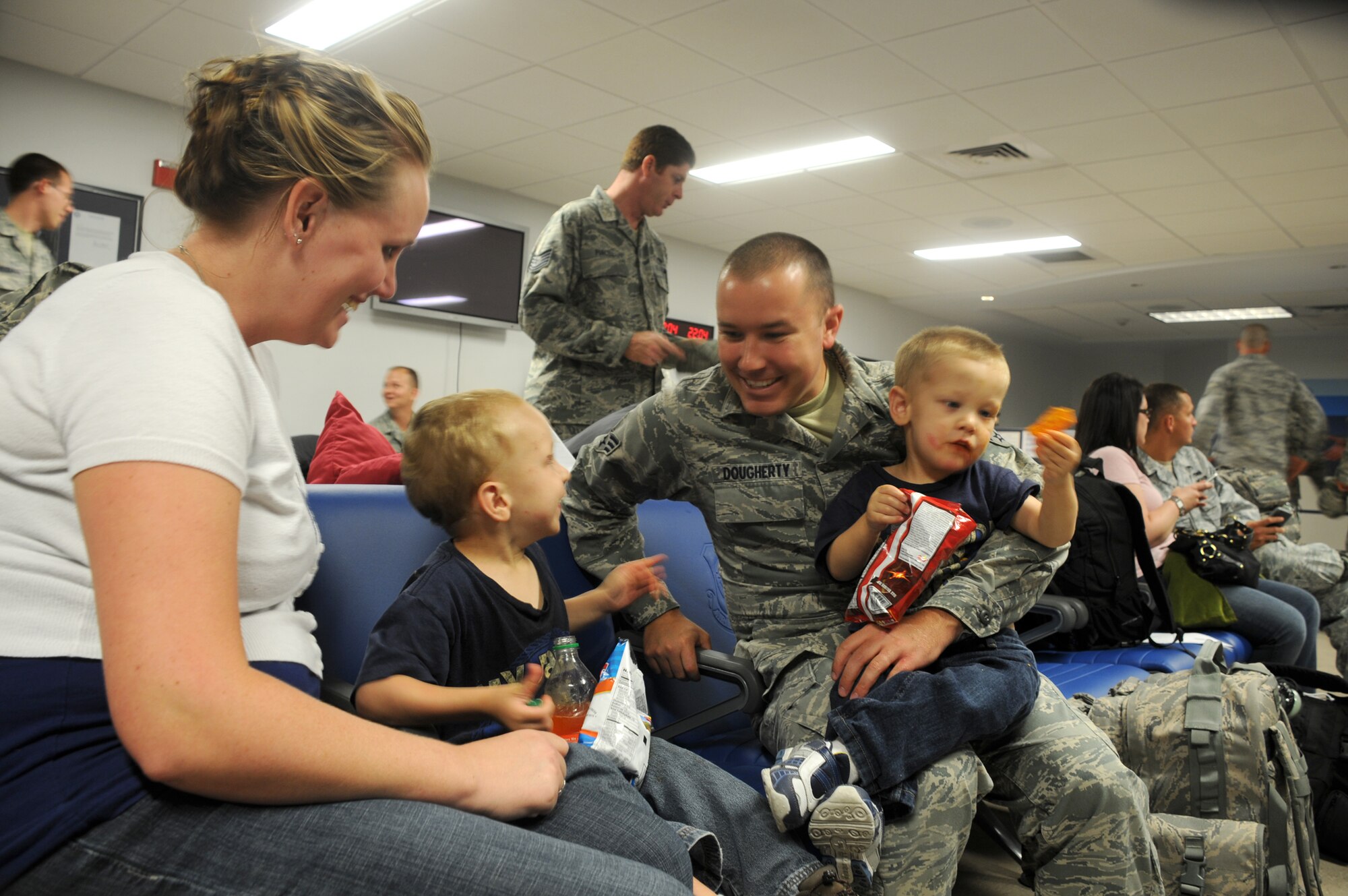 MacDill Air Force Base, Fla. --  Senior Airman Robert Dougherty, a reservist with the 927th Air Refueling Wing here, spends some precious minutes with his wife, Jessie, and his two boys Logan, 4, and Zack, 3, before deploying to the East Asia Theater of Operations.  Dougherty and other reservists tasked with the deployment left their families and jobs to serve their country overseas. 