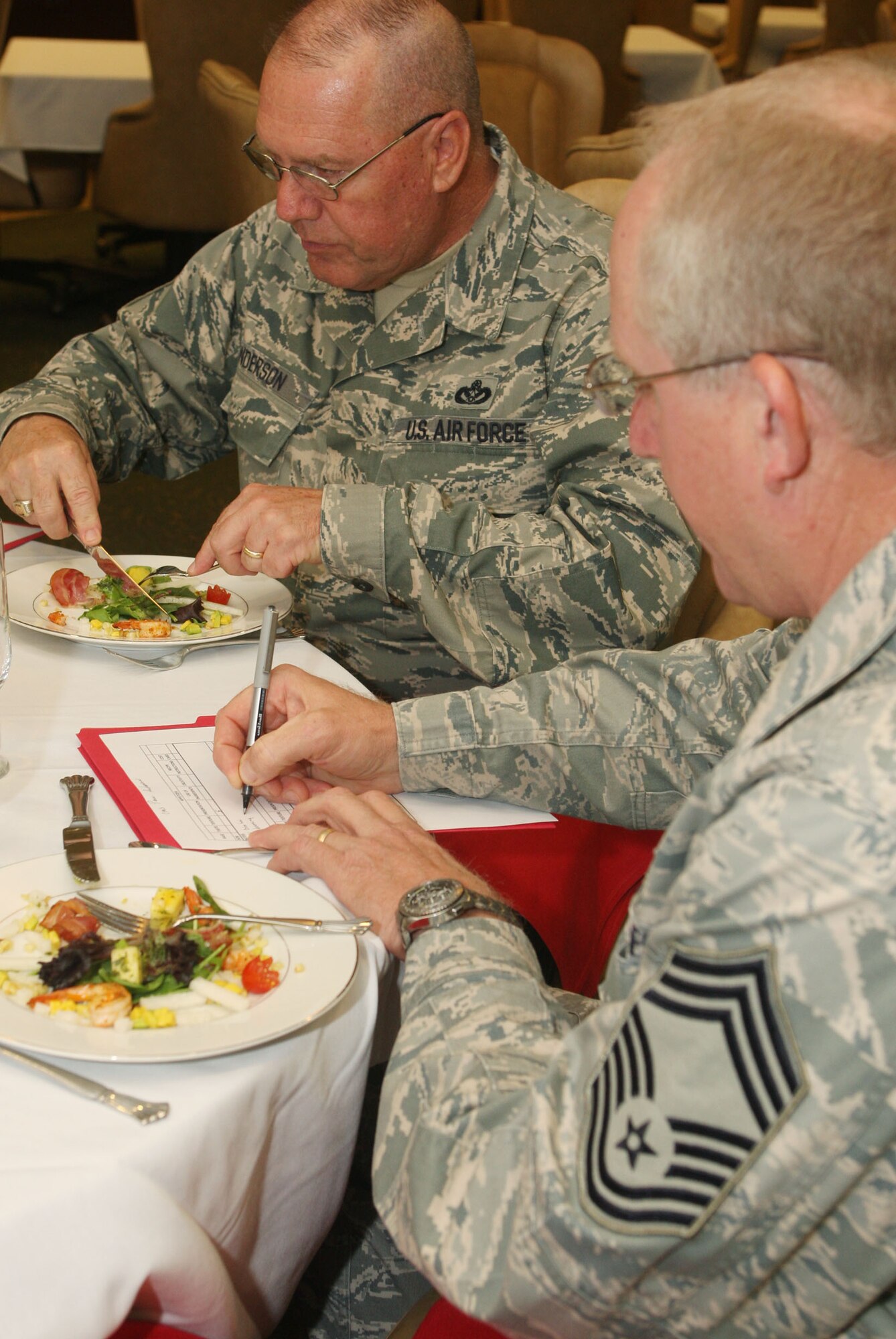 Judges Chief Master Sgt. John Anderson, 94th Airlift Wing Command Chief and Chief Master Sgt. Paul B. Anderson, from the 94th Maintenance Squadron taste and evaluate the appetizer portion of the Fer de Lance competition. (U.S. Air Force Photo/Don Peek)