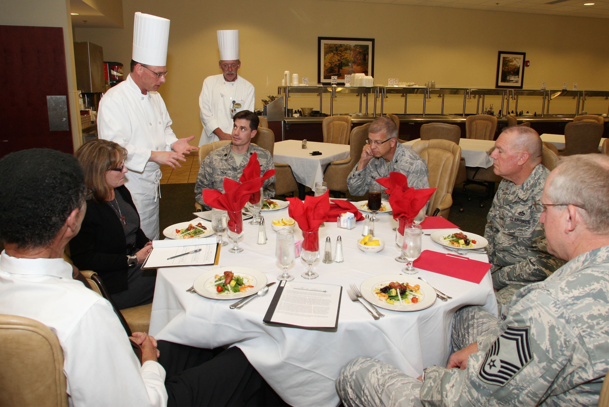 Chef Michael Medford from the 94th Services Squadron shares preparation details about the appetizer being served to the judges of the Fer de Lance competition. (U.S. Air Force Photo/Don Peek)