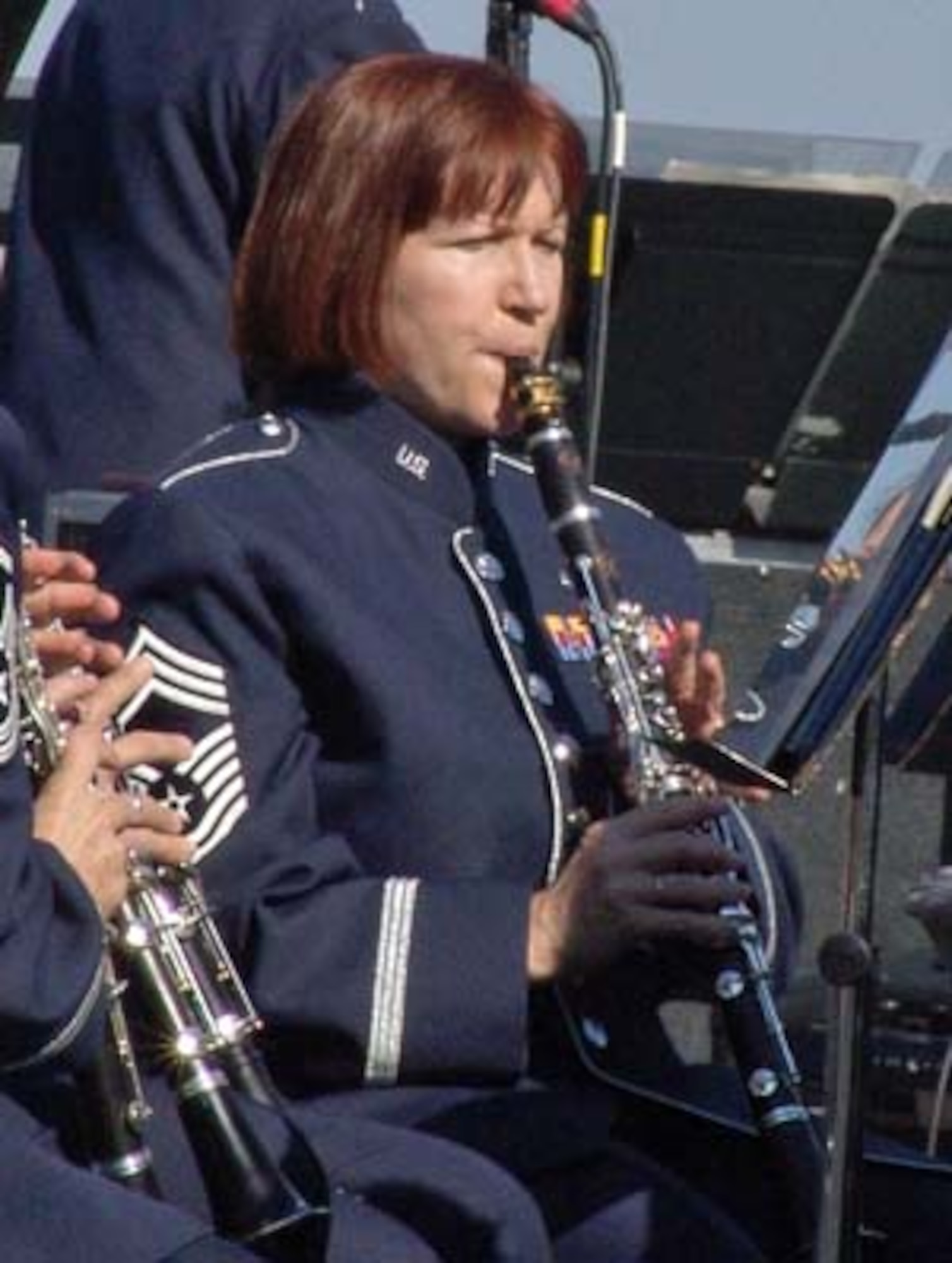 Chief Master Sgt. Elizabeth Schouten, Superintendent for The United States Air Force Band, will retire this spring, after 30 years of service in the Air Force.  She is seen here performing on B flat Clarinet at the Air Force Memorial on 14 Oct 2007 under the direction of former Commander Col. Dennis Layendecker.