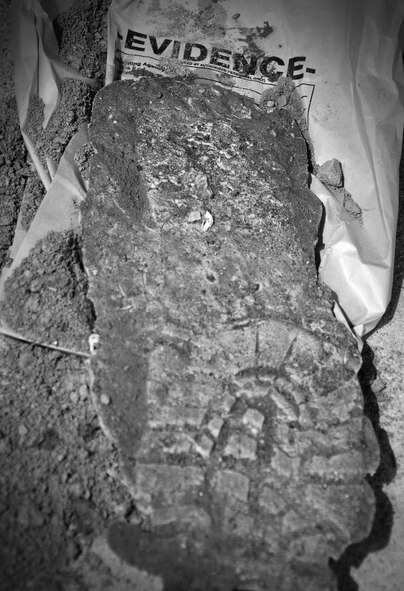 Proper procedures when photographing and molding shoe imprints were among the forensic procedures that were discussed here April 29. Osan’s AFOSI detachment took a recent opportunity to not only practice their own abilities but also teach and learn from local Republic of Korea air force members and Korean police investigators. The training included numerous crime scene investigation forensic techniques. (U.S. Air Force photo/Staff Sgt. Chad Thompson)