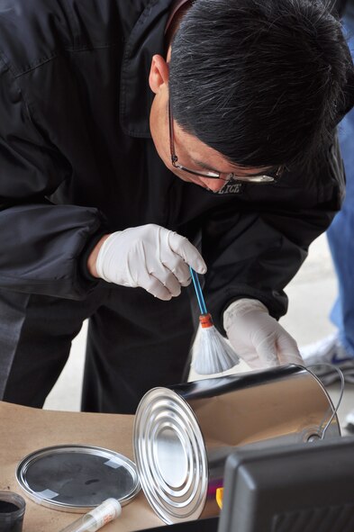 A Korean crime scene investigator practices fingerprinting techniques here April 29. Osan’s AFOSI detachment took a recent opportunity to not only practice their own abilities but also teach and learn from local Republic of Korea air force members and Korean police investigators. The training included numerous crime scene investigation forensic techniques. (U.S. Air Force photo/Staff Sgt. Chad Thompson)
