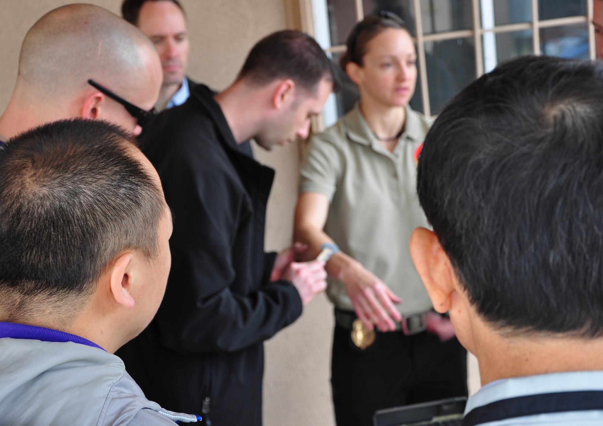 Special Agent Peter Van Damme applies a rubber mold on Special Agent Alison Babcock's arm to make a bite impression here April 29. Osan’s AFOSI detachment took a recent opportunity to not only practice their own abilities but also teach and learn from local Republic of Korea air force members and Korean police investigators. The training included numerous crime scene investigation forensic techniques. (U.S. Air Force photo/Staff Sgt. Chad Thompson)