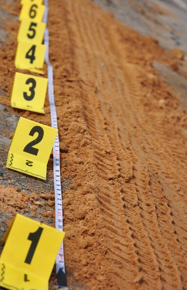 Proper procedures when photographing and molding tire imprints were among the forensic procedures that were discussed here April 29. Osan’s AFOSI detachment took a recent opportunity to not only practice their own abilities but also teach and learn from local Republic of Korea air force members and Korean police investigators. The training included numerous crime scene investigation forensic techniques. (U.S. Air Force photo/Staff Sgt. Chad Thompson)