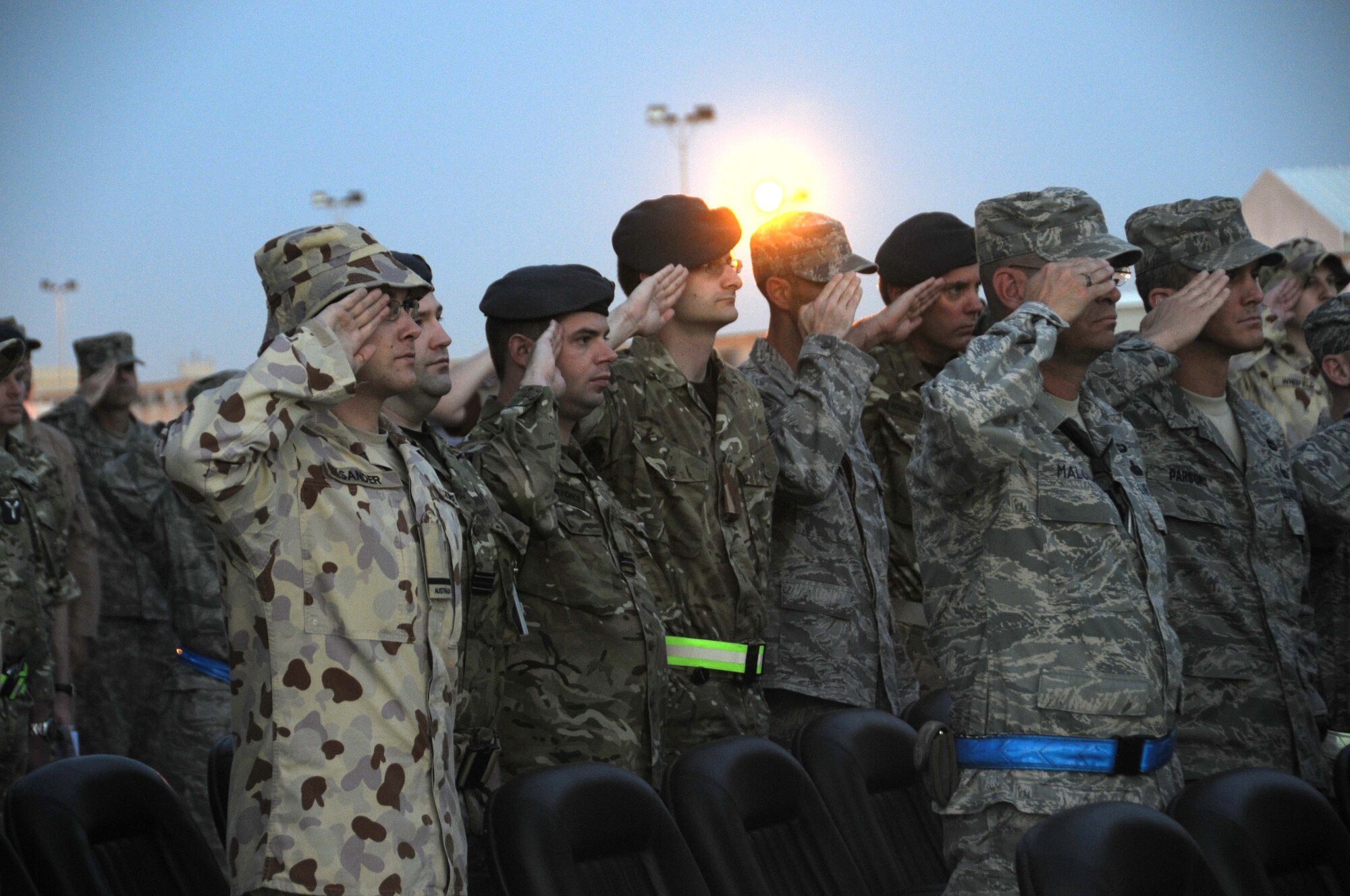 Members from the Australian Air Force, Royal Air Force and U.S. Air Force salute to pay tribute during the ANZAC (Australian and New Zealand Army Corps) Day celebration April 25 in Southwest Asia.   This year marks the 96th anniversary of the first major engagement of Australian and New Zealand troops in World War I. It is now observed as a national day of reflection on the lives lost in war. (U.S. Air Force photo/Staff Sgt. Anthony Graham)
