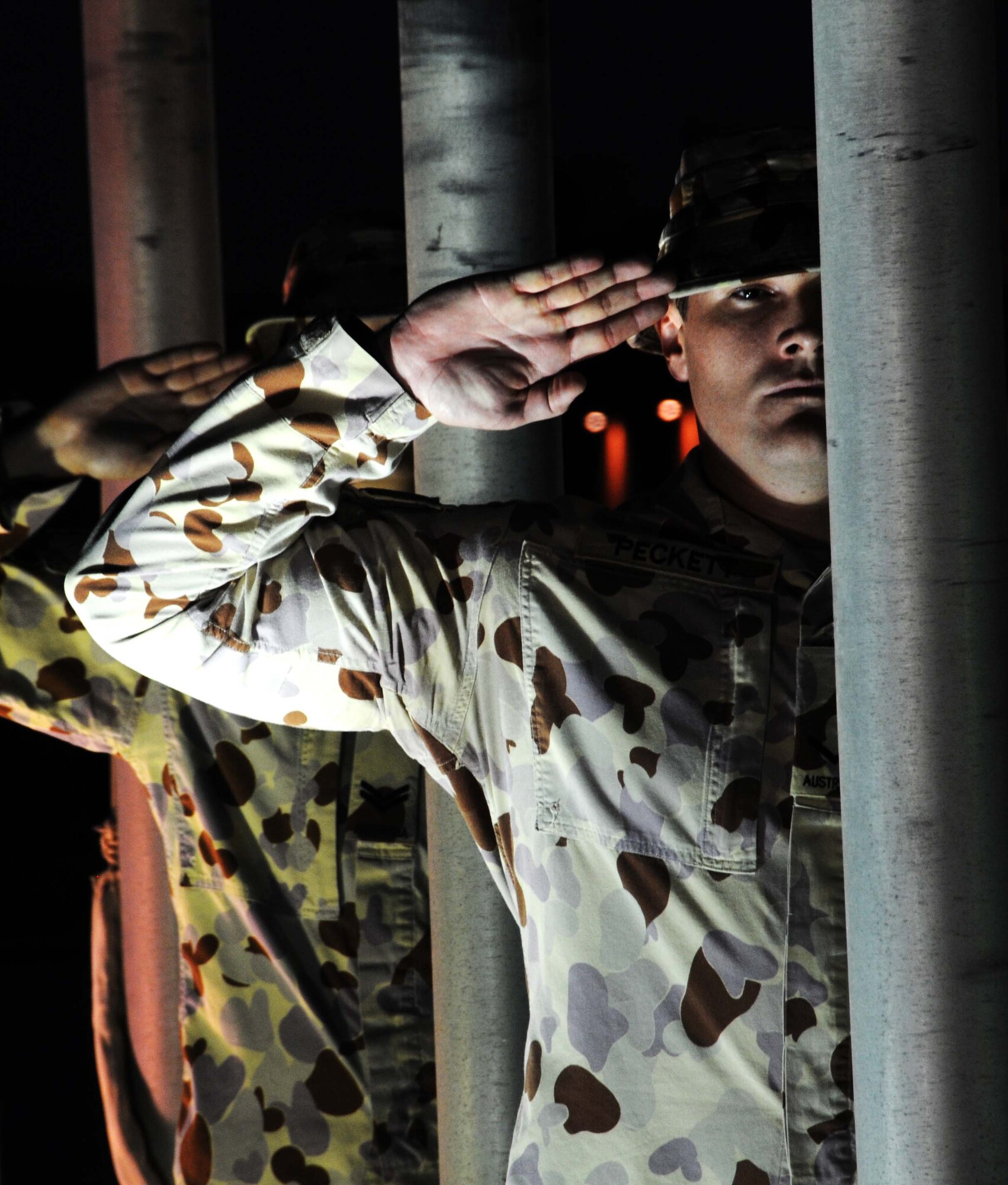 Leading Air Craftsman (LAC) Dwayne Peckett, Royal Australian Air Force, salutes during the ANZAC (Australian and New Zealand Army Corps) Day celebration here April 25 in Southwest Asia.  This year marks the 96th anniversary of the first major engagement of Australian and New Zealand troops in World War I. It is now observed as a national day of reflection on the lives lost in war. (U.S. Air Force photo/Staff Sgt. Anthony Graham)