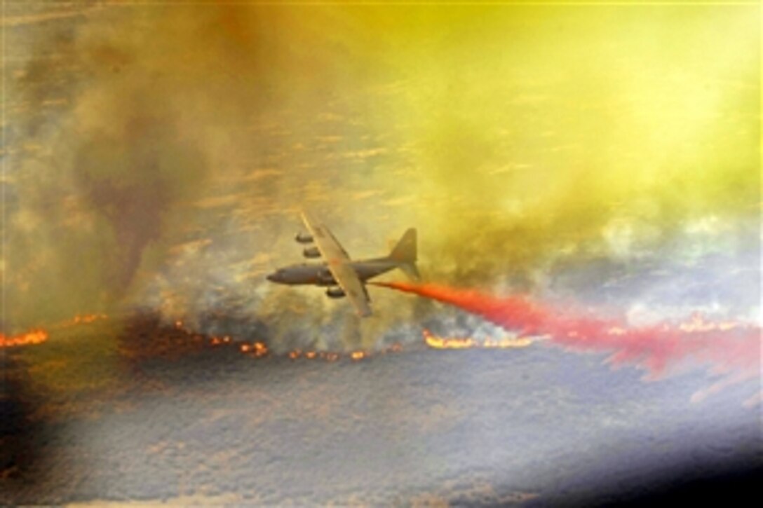 A C-130H Hercules aircraft equipped with the Modular Airborne Firefighting System drops a line of fire retardant in west Texas on April 27, 2011.  The C-130 crew is assigned to the 302nd Airlift Wing, Colorado Springs Air Force Reserve.  The modular system is capable of dispensing 3,000 gallons of water or fire retardant in less than five seconds.  
