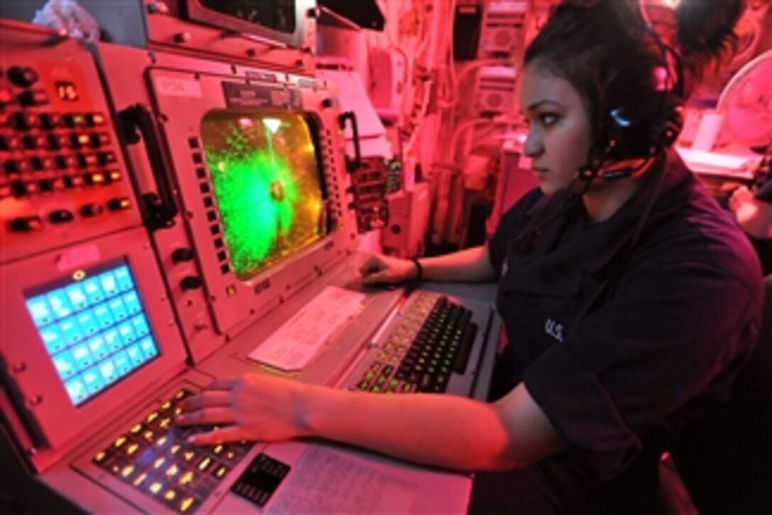 Seaman Nathalie G. Sanchez operates an advanced combat direction system console in the commanding officer's tactical plot room aboard the aircraft carrier USS Enterprise (CVN 65) in the Arabian Gulf on April 26, 2011.  The Enterprise and Carrier Air Wing 1 are conducting operations supporting Operation New Dawn in the U.S. 5th Fleet area of responsibility.  